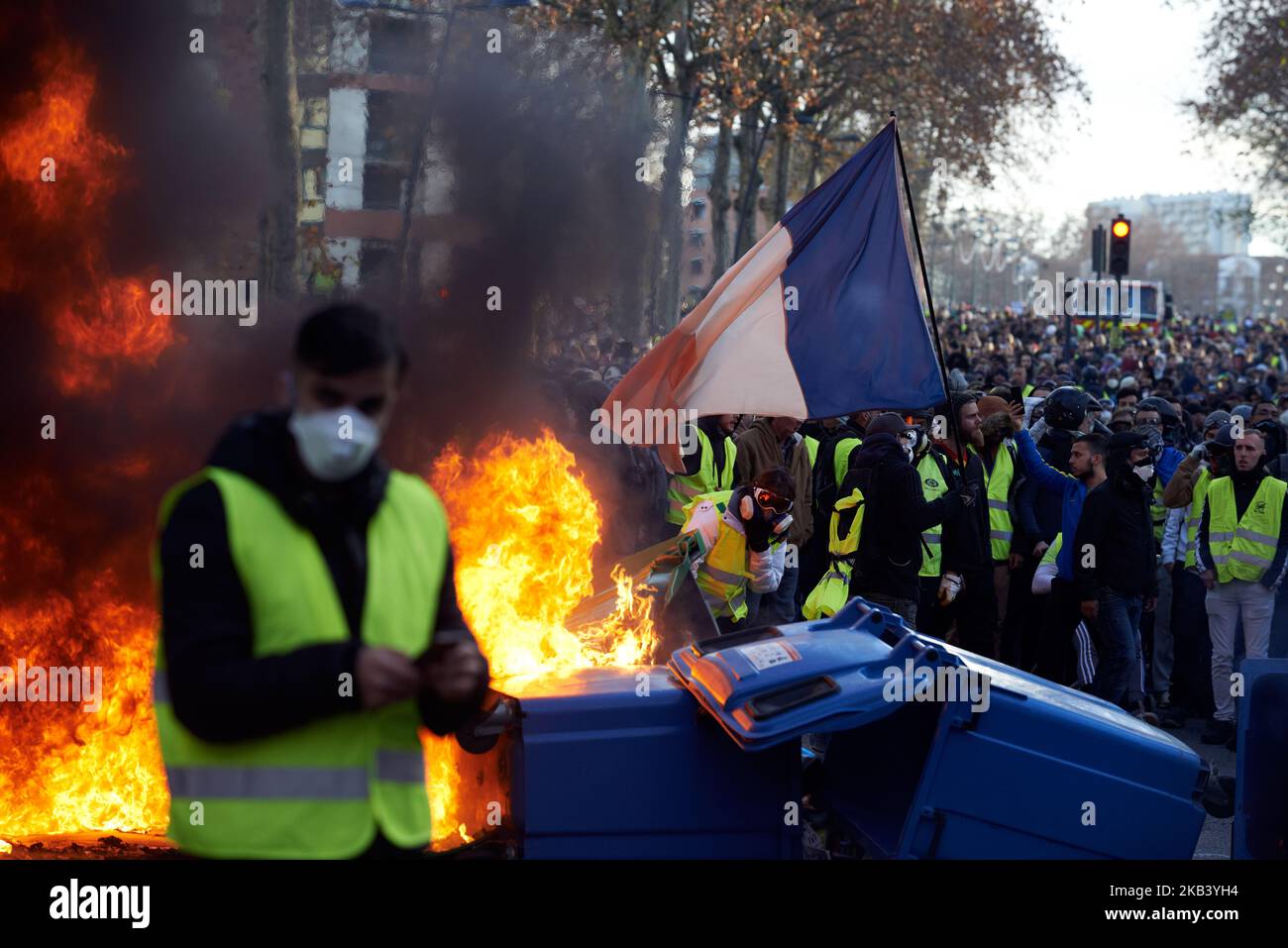 A protester waves a French flag on a barricade.After the begining of a ...