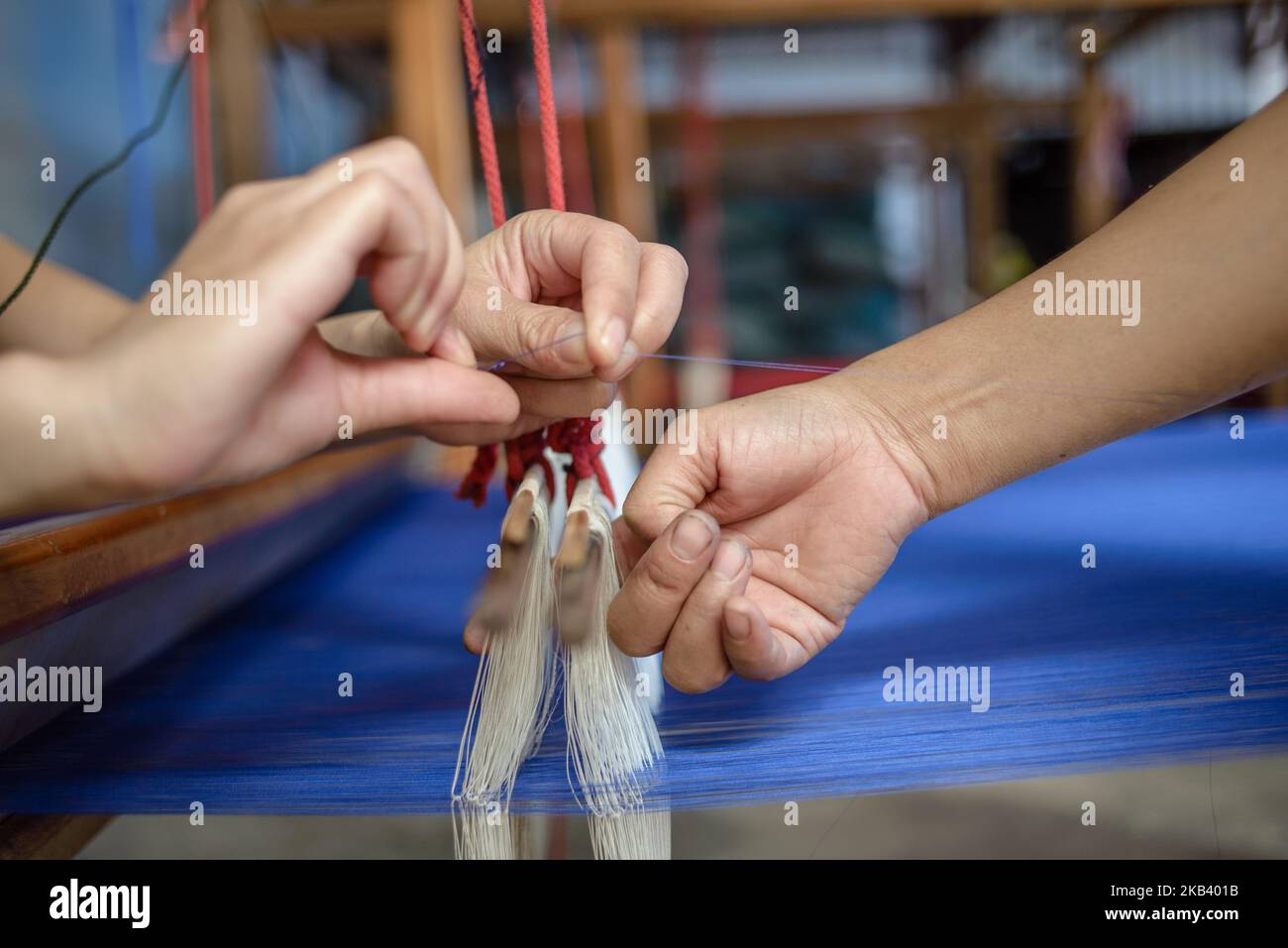 Silk weaving process at the Mai Savanh Lao workshop in Vientiane, Laos on December 10, 2018. (Photo by Oleksandr Rupeta/NurPhoto) Stock Photo