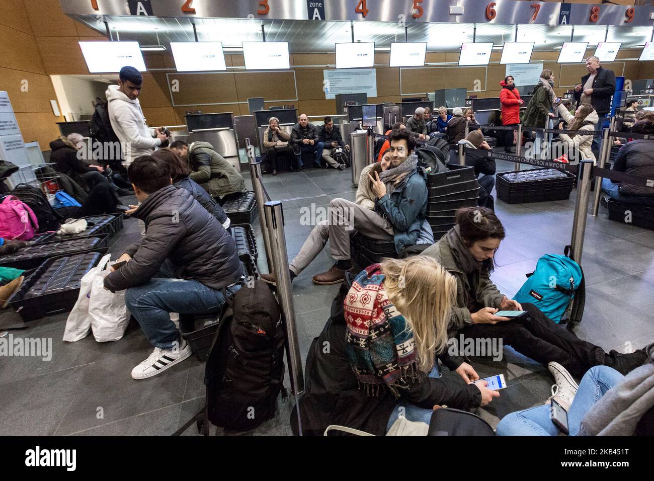 Hundreds of passengers try to rest on the floor of Brussels Charleroi