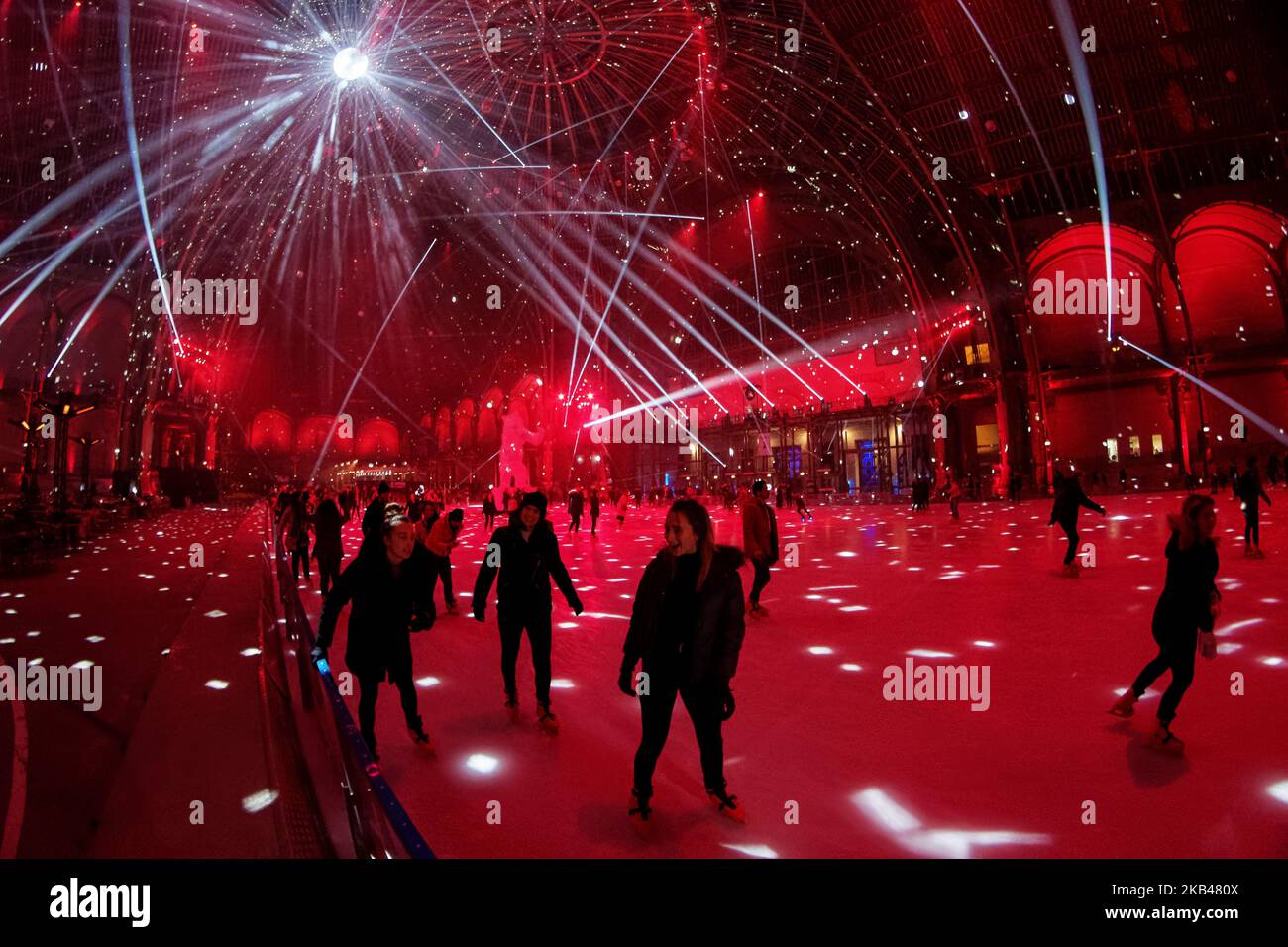 The ice skating rink open to the public during the Christmas holydays hosted under the glass dome of Grand Palais in Paris during the evenings of the end of the year to celebrate holydays and new year. Ligth show , Music with DJ set, and 'Ours' of Richard Orlinski enjoy the people which skating - December 20, 2018 - Paris (Photo by Daniel Pier/NurPhoto)  Stock Photo
