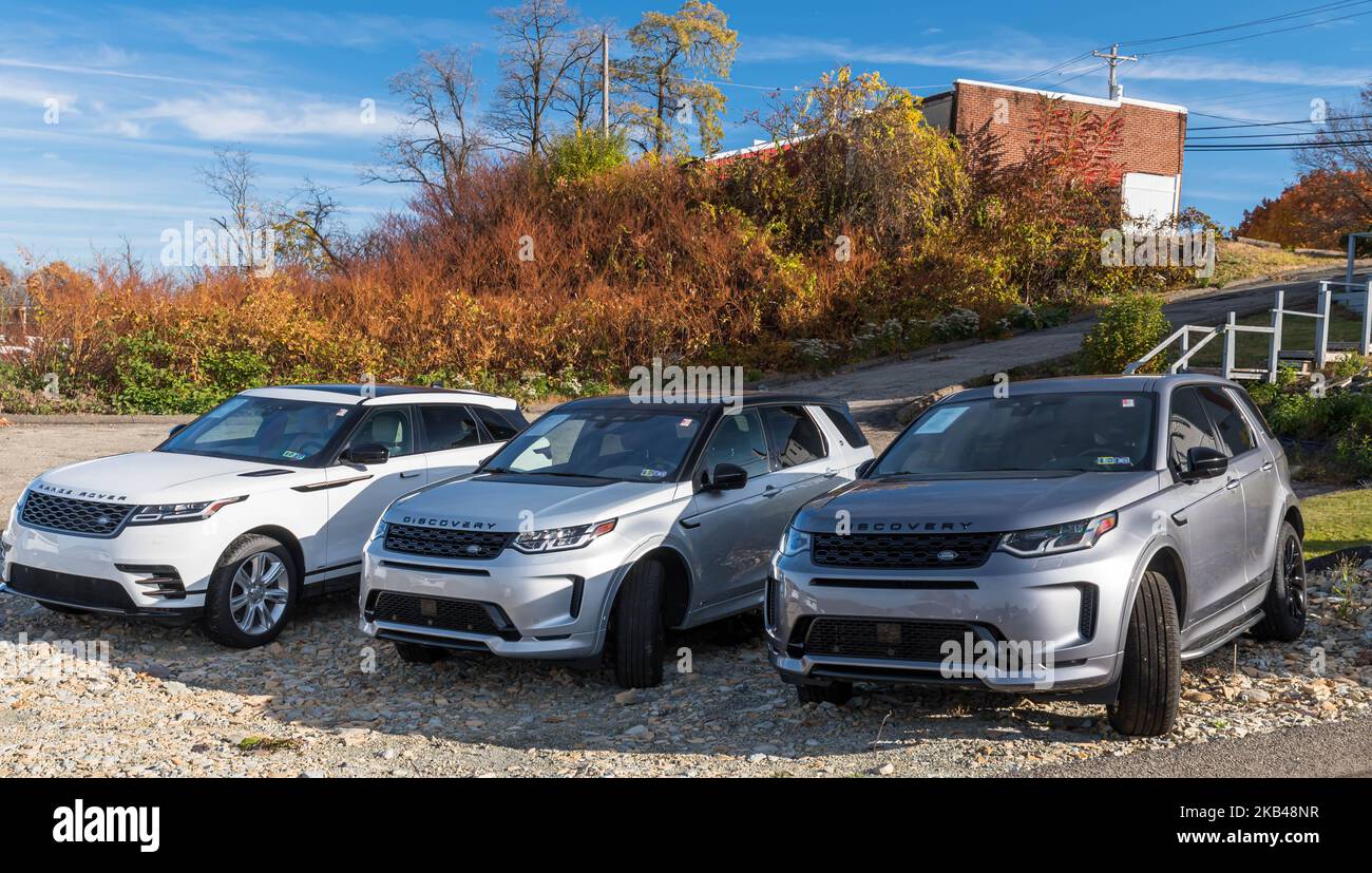 Three different types of Range Rover SUVs for sale at a dealership in