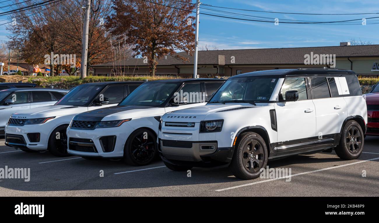 Three different types of white Range Rover SUVs for sale at a
