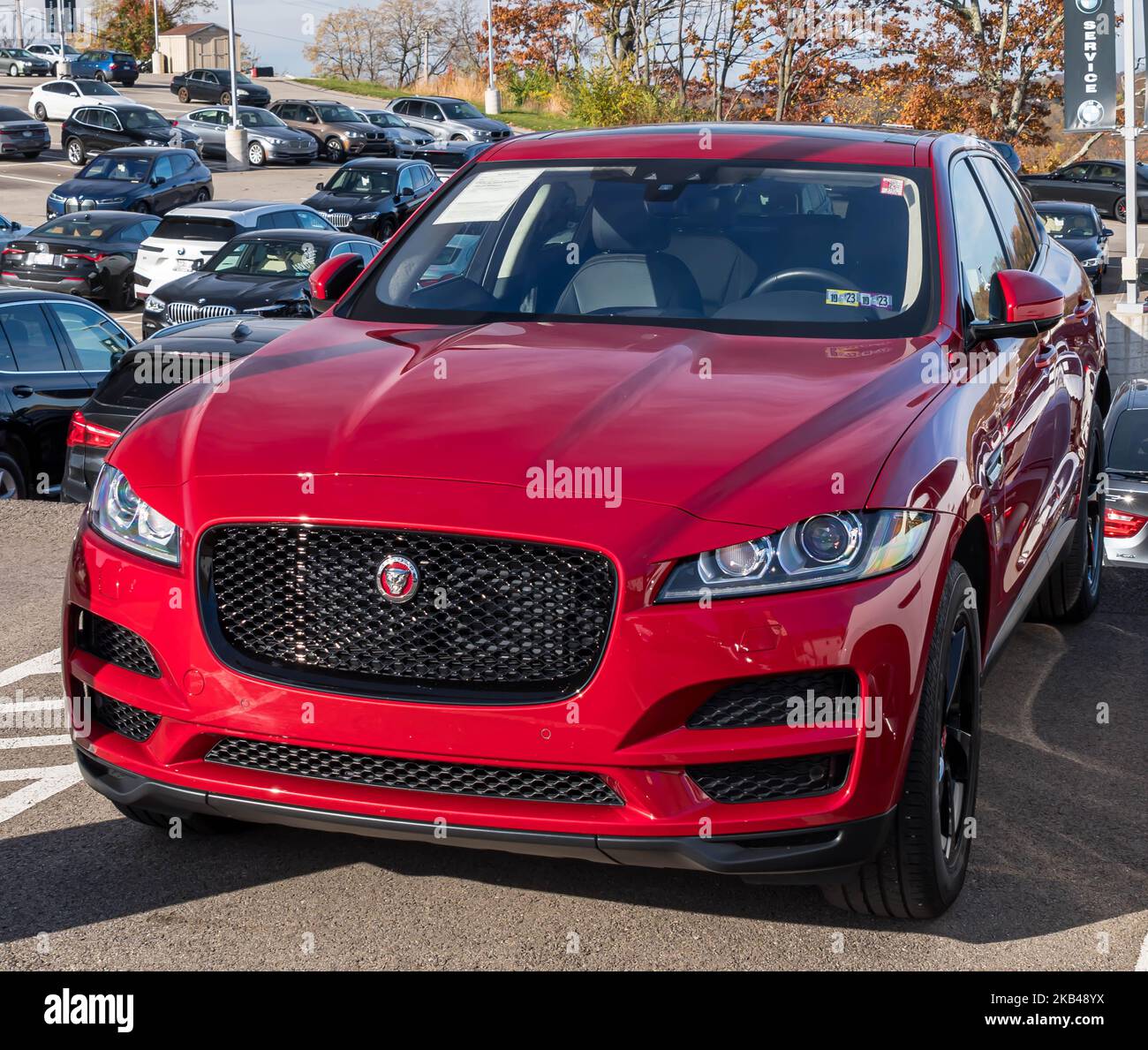 A red Jaguar sedan for sale at a dealership in Monroeville