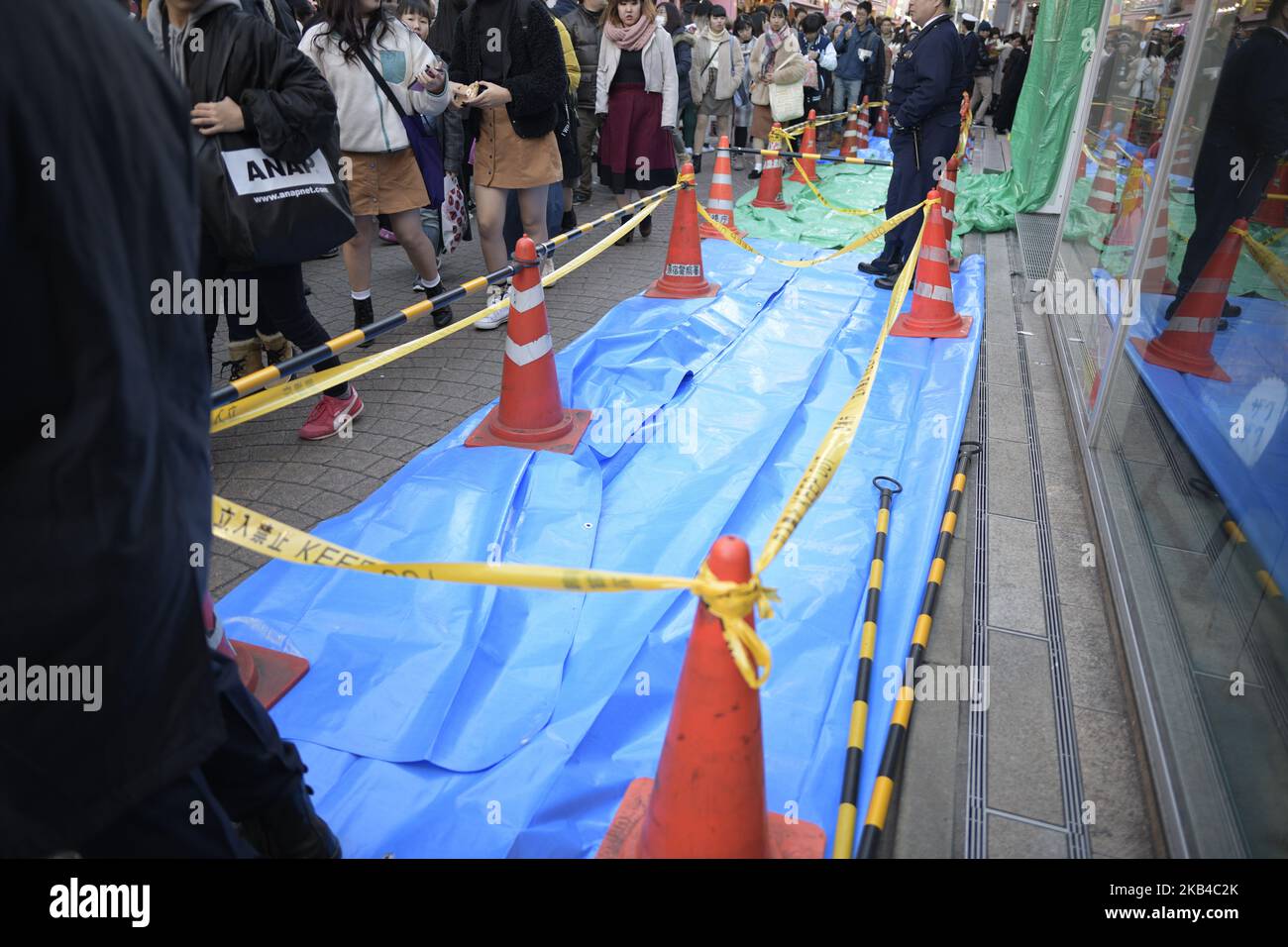Policemen stand next to a crime scene which plowed into pedestrians in Harajuku, Tokyo, Japan on January 1, 2019. Police arrested Kazuhiro Kusakabe, 21, who was driving the rental car with an Osaka license plate, on suspicion of attempted murder. (Photo by Richard Atrero de Guzman/NurPhoto) Stock Photo