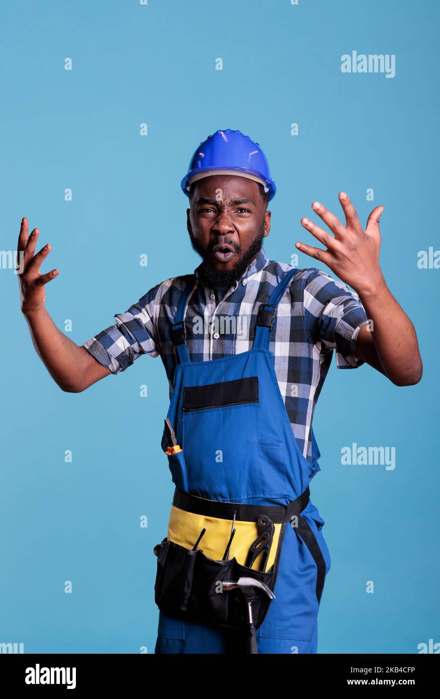 Violent and angry builder expressing anger and annoyance in the studio