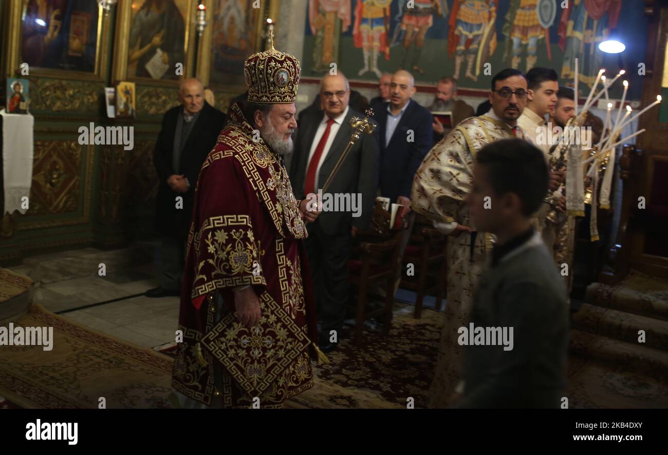 Palestinian Orthodox Christians attend a mass in the Church of Saint