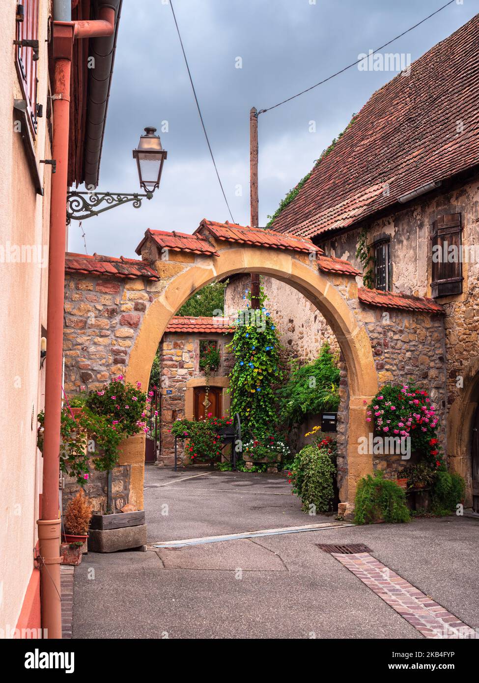 Rouffach, France - October 11, 2022: Vertical photo of the traditional courtyard arch of an old house in Rouffach, Alsace, France Stock Photo