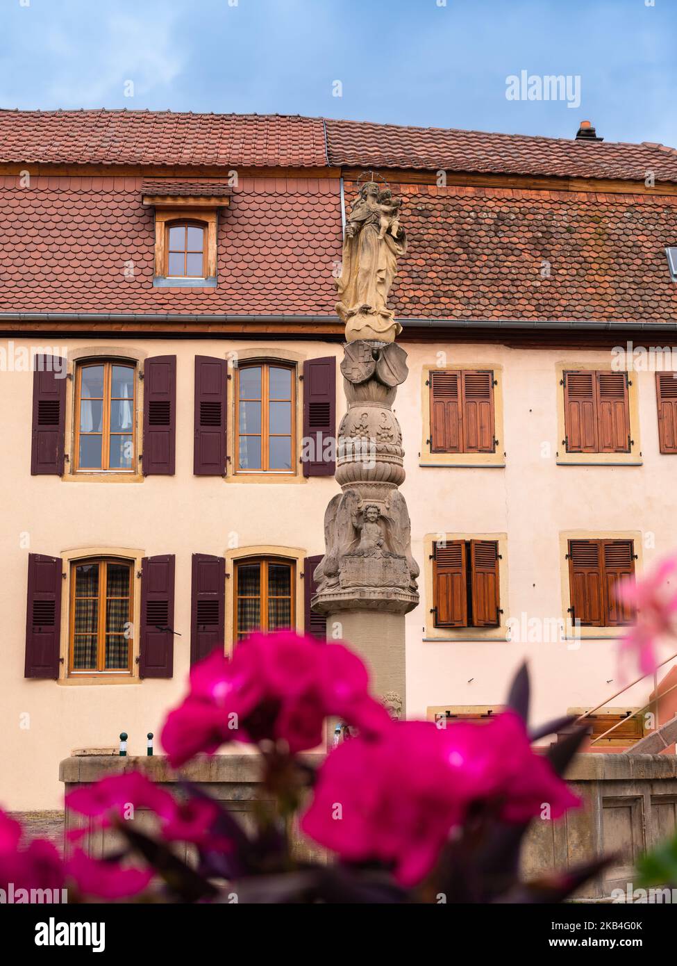 Rouffach, France - October 11, 2022: Medieval sculpture with a statue of Mary with Jesus in Rouffach, Alsace, France Stock Photo