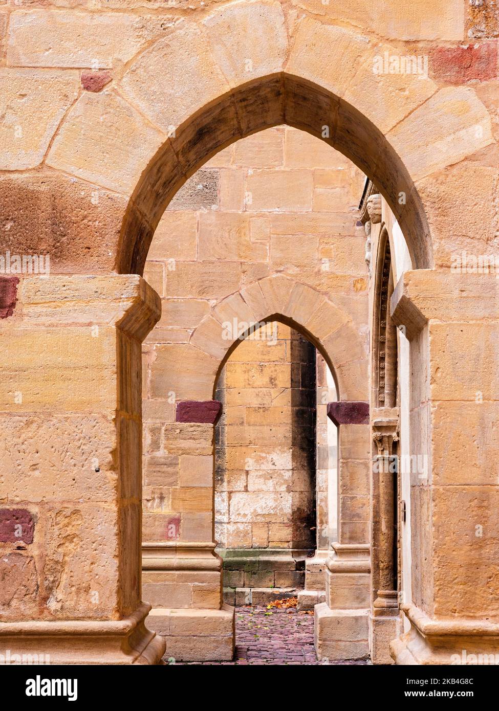 Stone arches of the Romanesque-Gothic Church of the Assumption in Rouffach, Alsace, France Stock Photo