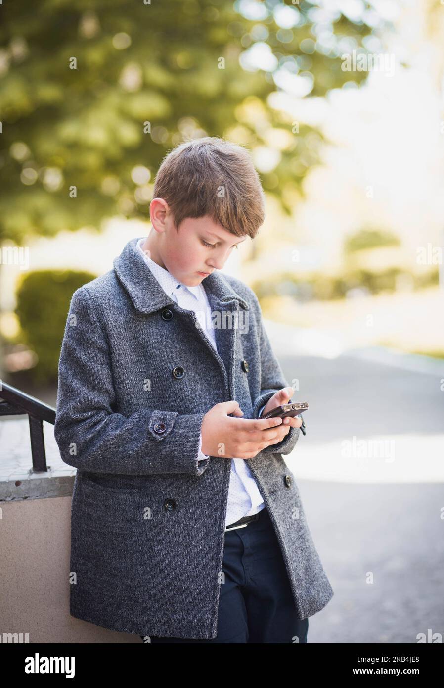 Bila Tserkva, Ukraine, May, 2017: schoolboy playing on the phone Stock Photo