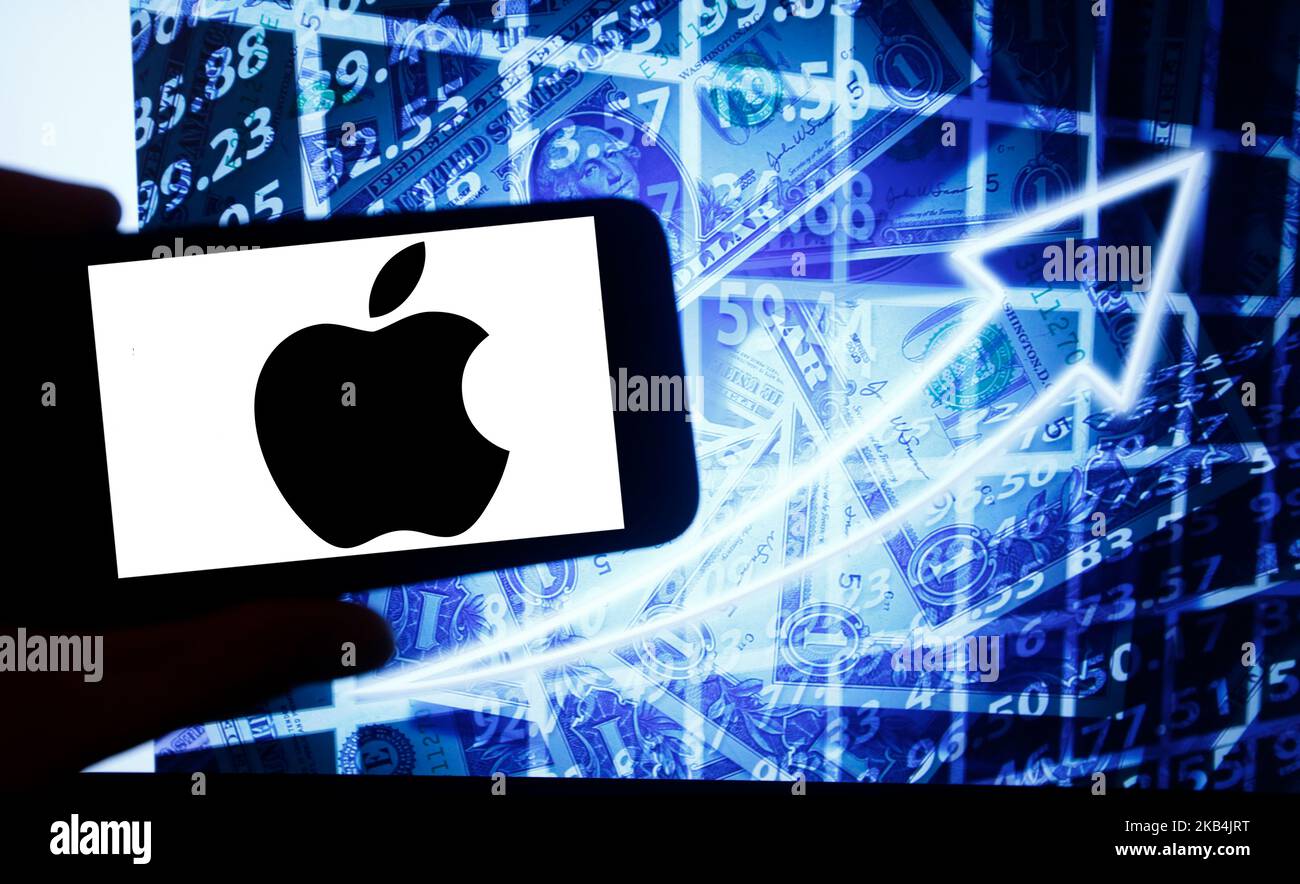 The logo of Apple is seen on a screen of a smartphone next to a screen with an illustration ofthe stock market. Apple is listed in Nasdaq. The Nasdaq is the second-largest stock exchange in the world after the New York Stock Exchange. (Photo by Alexander Pohl/NurPhoto) Stock Photo