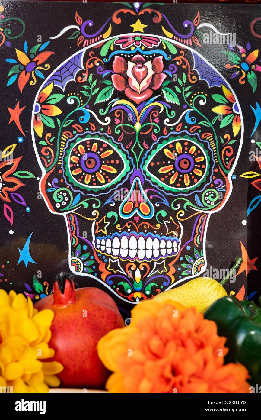 A colorful painted skull with marigold flowers is part of a Dia de los Muertos (Day of the Dead) festival Stock Photo