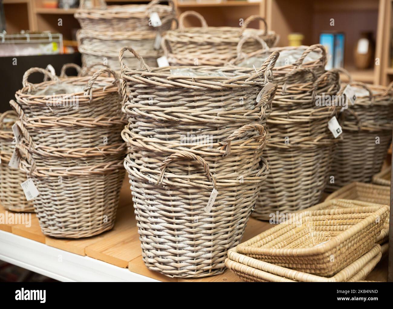 Wicker baskets on shelves in store Stock Photo Alamy