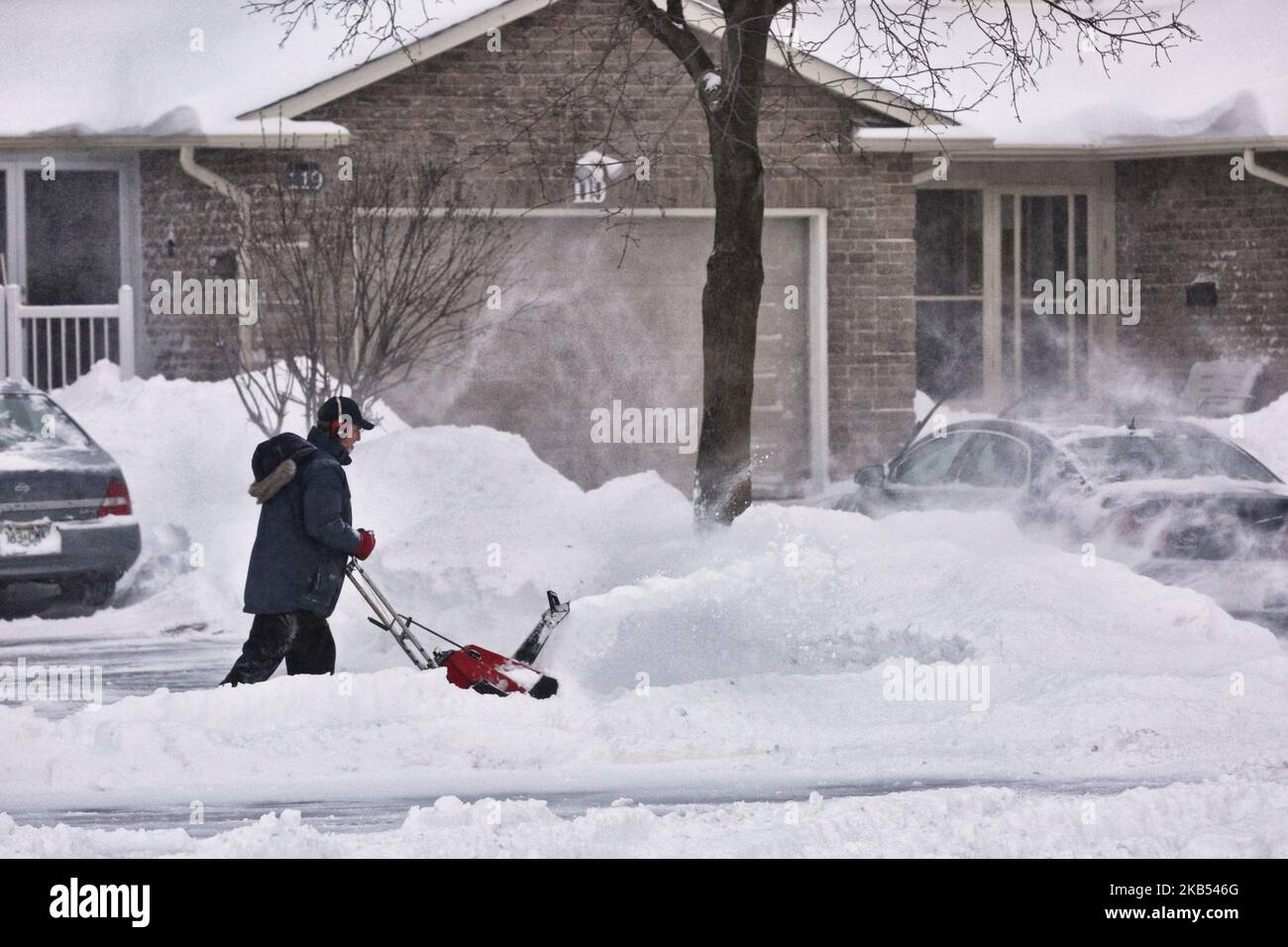 Man uses a snow-blower to clear snow from his driveway after a massive snowstorm hit Toronto, Ontario, Canada, on January 28, 2019. The storm dropped between 15-25 centimeters of snow across the Greater Toronto Area and broke the record for snowfall amount set in January 2009, with more than 22cm falling before midnight yesterday. (Photo by Creative Touch Imaging Ltd./NurPhoto) Stock Photo