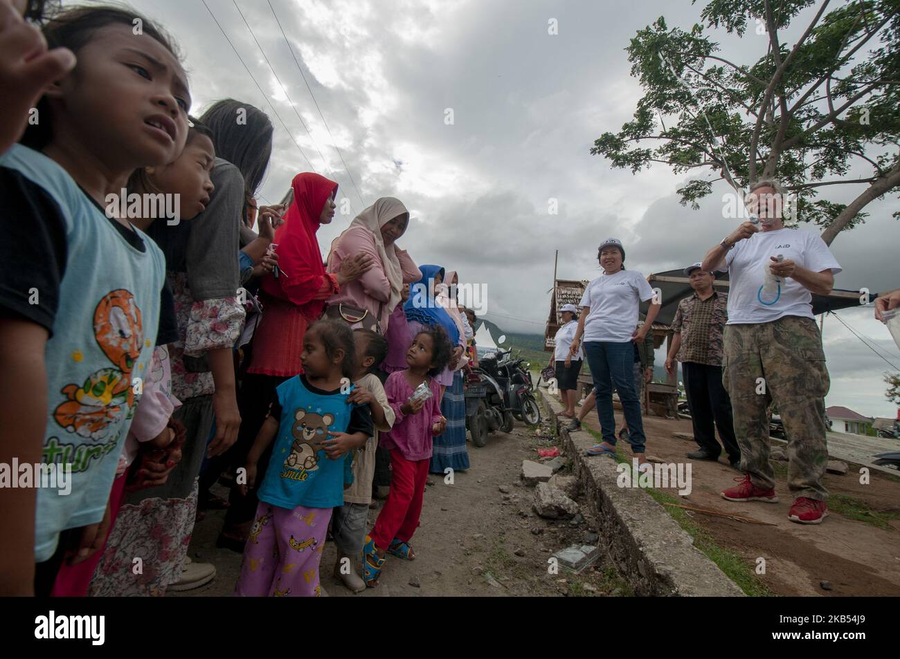 Activists of international humanitarian agency iAID demonstrated the use of drinking water refiners to earthquake victims in the Refugee Camp of Duyu Village, Palu, Central Sulawesi, Indonesia, Wednesday, January 30, 2019. A number of international humanitarian agencies took part in helping victims of the earthquake, tsunami and liquefaction in Palu , Sigi, and Donggala, which according to data validated by the local government caused at least 4,340 lives to be killed, more than 90,000 houses damaged, and 72,999 people displaced. (Photo by Basri Marzuki/NurPhoto) Stock Photo