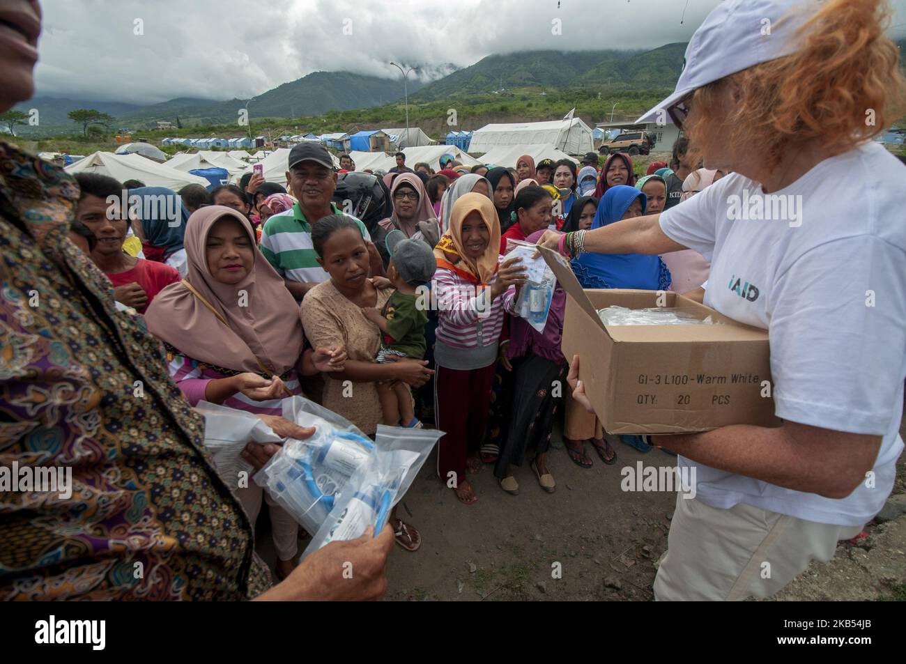 Activists of international humanitarian agencies iAID distributed drinking water refiners to earthquake victims in the Refugee Camp of Duyu Village, Palu, Central Sulawesi, Indonesia, Wednesday, January 30, 2019. A number of international humanitarian agencies took part in helping victims of the earthquake, tsunami and liquefaction in Palu , Sigi, and Donggala, which according to data validated by the local government caused at least 4,340 lives to be killed, more than 90,000 houses damaged, and 72,999 people displaced. (Photo by Basri Marzuki/NurPhoto) Stock Photo