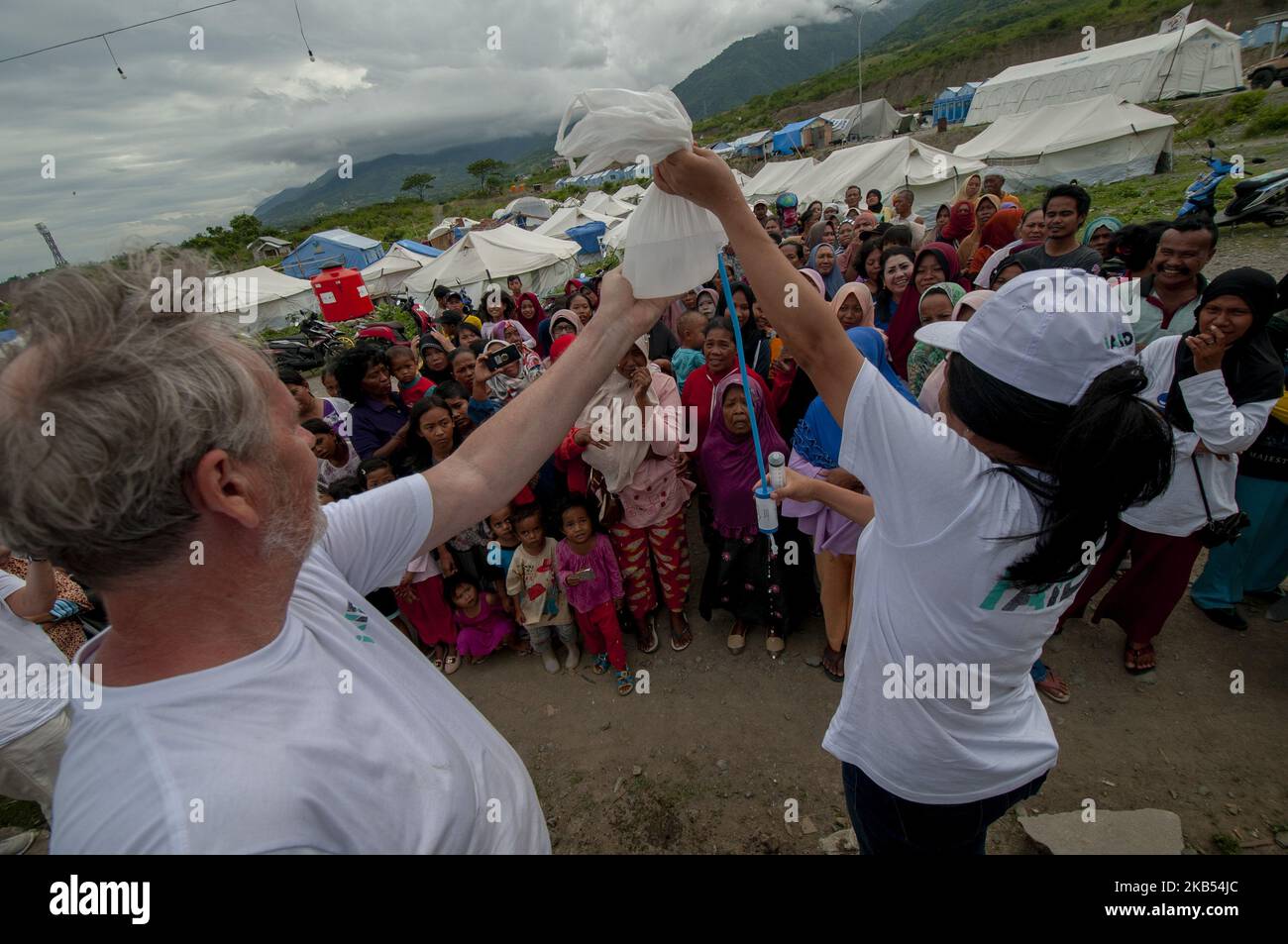 Activists of international humanitarian agency iAID demonstrated the use of drinking water refiners to earthquake victims in the Refugee Camp of Duyu Village, Palu, Central Sulawesi, Indonesia, Wednesday, January 30, 2019. A number of international humanitarian agencies took part in helping victims of the earthquake, tsunami and liquefaction in Palu , Sigi, and Donggala, which according to data validated by the local government caused at least 4,340 lives to be killed, more than 90,000 houses damaged, and 72,999 people displaced. (Photo by Basri Marzuki/NurPhoto) Stock Photo