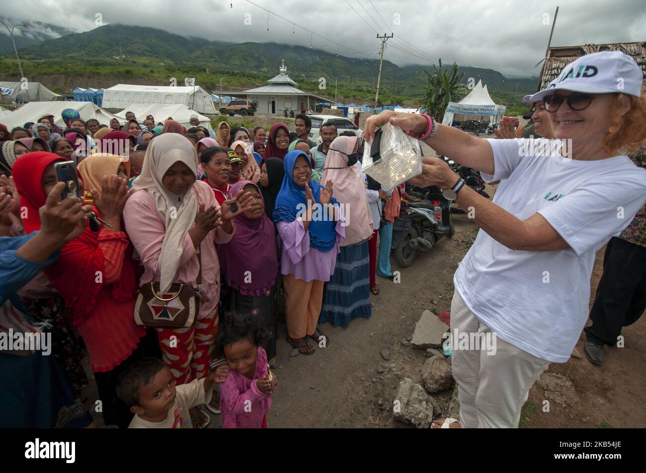 Activists of international humanitarian agency iAID demonstrated the use of drinking water refiners to earthquake victims in the Refugee Camp of Duyu Village, Palu, Central Sulawesi, Indonesia, Wednesday, January 30, 2019. A number of international humanitarian agencies took part in helping victims of the earthquake, tsunami and liquefaction in Palu , Sigi, and Donggala, which according to data validated by the local government caused at least 4,340 lives to be killed, more than 90,000 houses damaged, and 72,999 people displaced. (Photo by Basri Marzuki/NurPhoto) Stock Photo