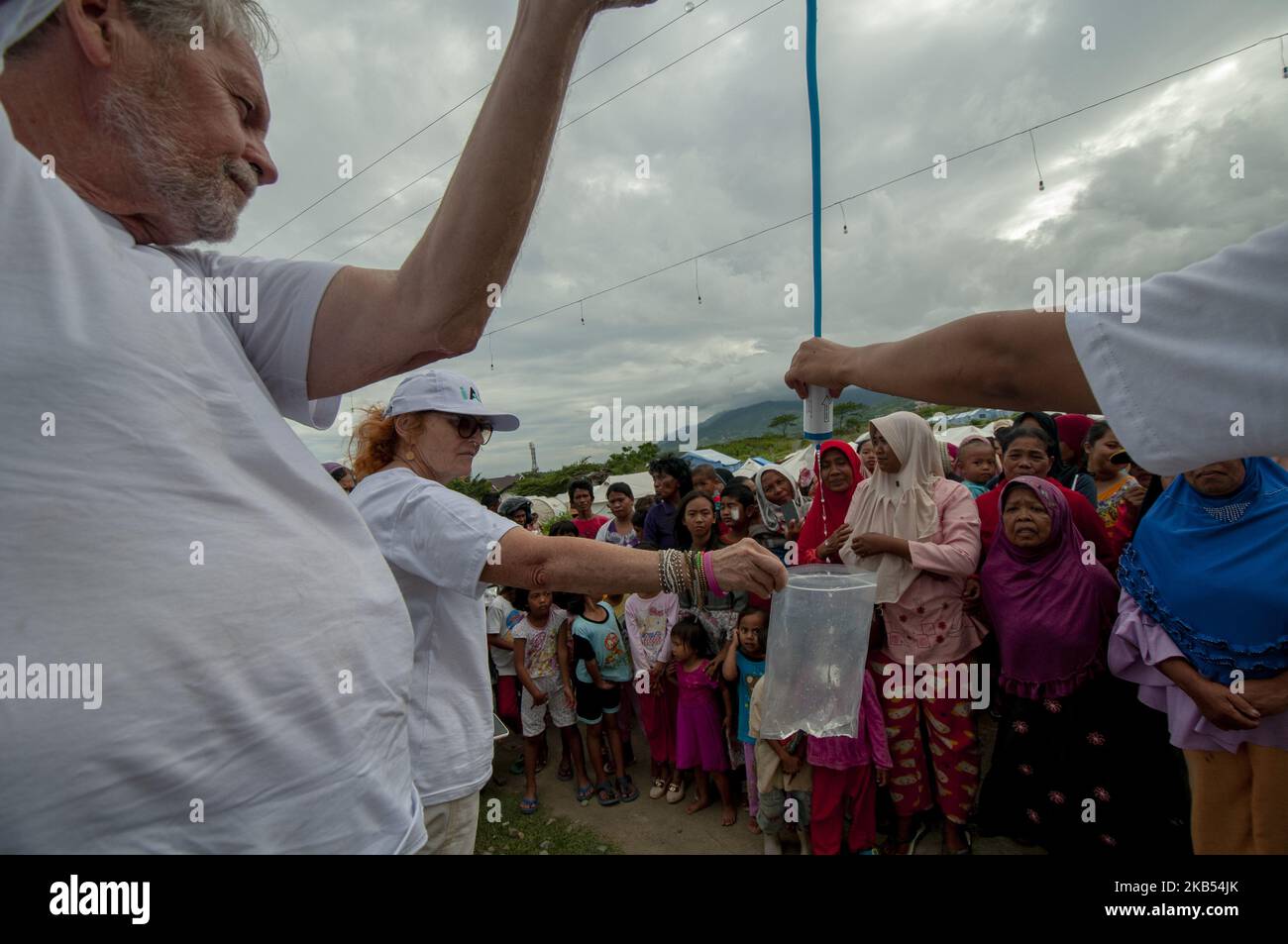 Activists of international humanitarian agency iAID demonstrated the use of drinking water refiners to earthquake victims in the Refugee Camp of Duyu Village, Palu, Central Sulawesi, Indonesia, Wednesday, January 30, 2019. A number of international humanitarian agencies took part in helping victims of the earthquake, tsunami and liquefaction in Palu , Sigi, and Donggala, which according to data validated by the local government caused at least 4,340 lives to be killed, more than 90,000 houses damaged, and 72,999 people displaced. (Photo by Basri Marzuki/NurPhoto) Stock Photo