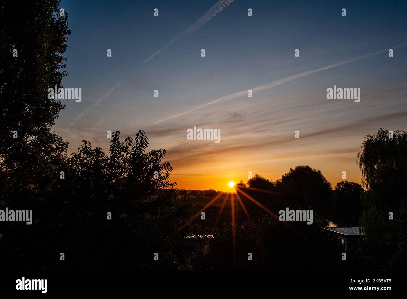 View of a beautiful Sunrise In Nijmegen, Netherlands, on 6 September 2019. The Ooijpolder is a beautiful area for walking and recreation close to the Waalbrug bridge and surrounded by the Waal river. The area is located east of the city of Nijmegen in the province of Gelderland. It is characterized by a vast landscape with small villages, farms and beautiful nature. (Photo by Romy Arroyo Fernandez/NurPhoto) Stock Photo