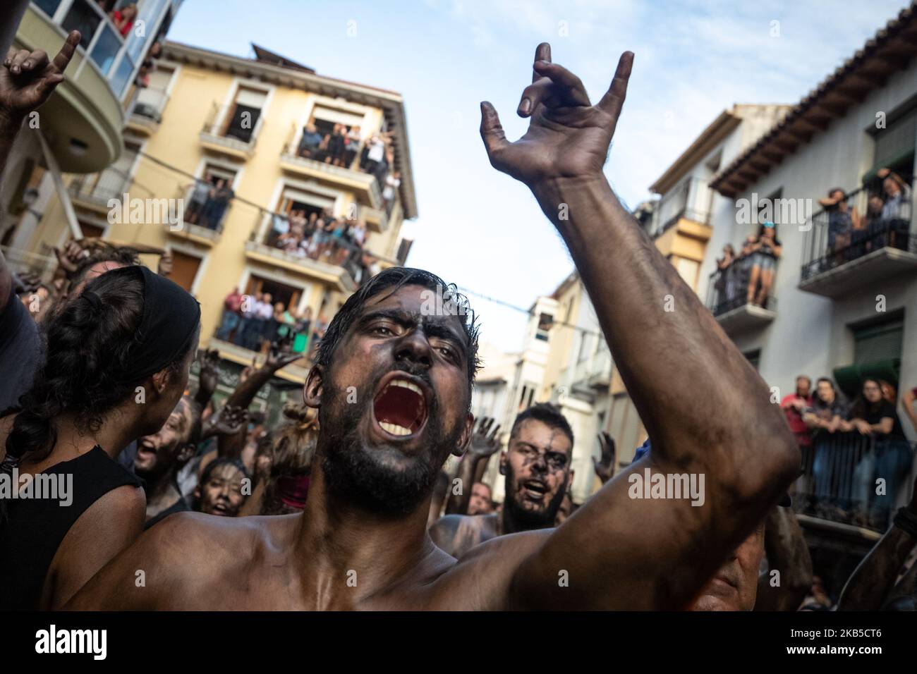 a-man-covered-in-black-grease-takes-part-in-the-traditional-festival-of