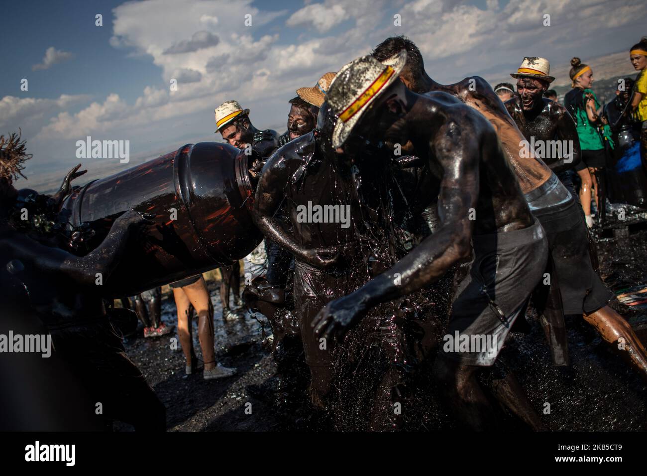 young-people-impregnate-a-friend-with-black-grease-during-the
