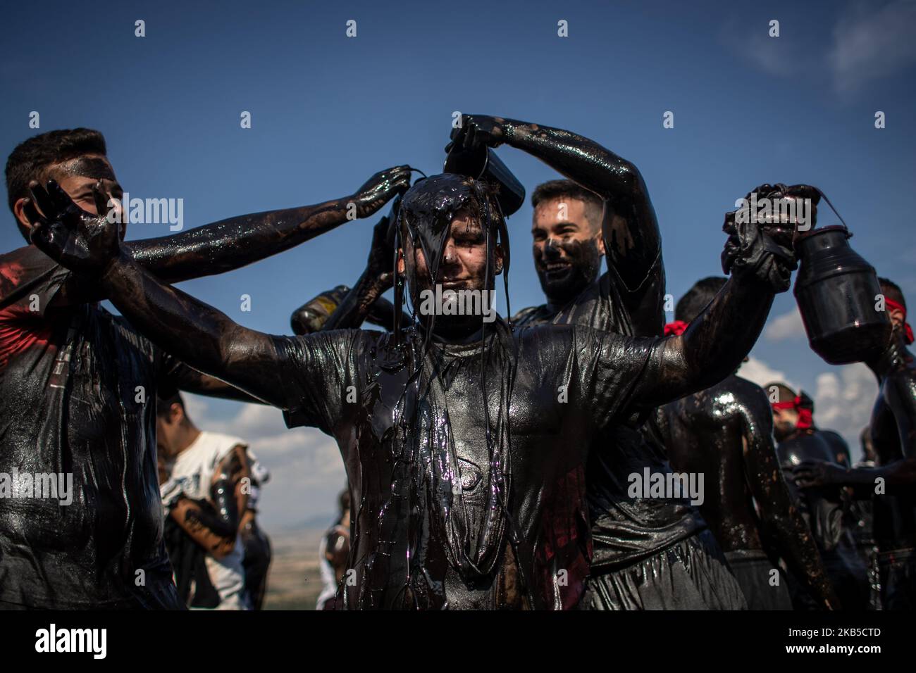 young-people-impregnate-a-friend-with-black-grease-during-the