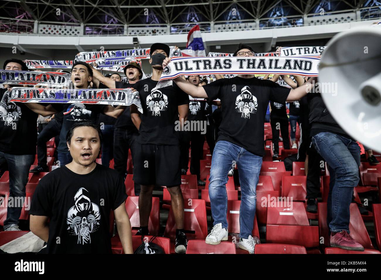 Thailand's fans shout slogans during FIFA World Cup 2022 qualifying match between Indonesia and Thailand at the Gelora Bung Karno stadium in Jakarta, Indonesia, September 10, 2019. (Photo by Andrew Gal/NurPhoto) Stock Photo