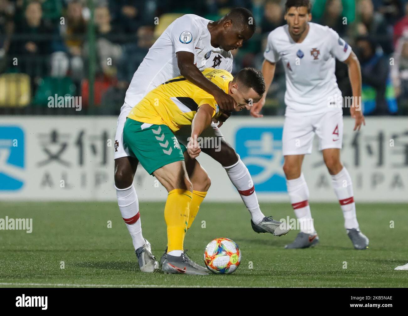 Deimantas Petravicius (in front) of Lithuania and William Carvalho of Portugal vie for the ball during the UEFA Euro 2020 qualifying match between Lithuanua and Portugal on September 10, 2019 at LFF Stadium in Vilnius, Lithuania. (Photo by Mike Kireev/NurPhoto) Stock Photo
