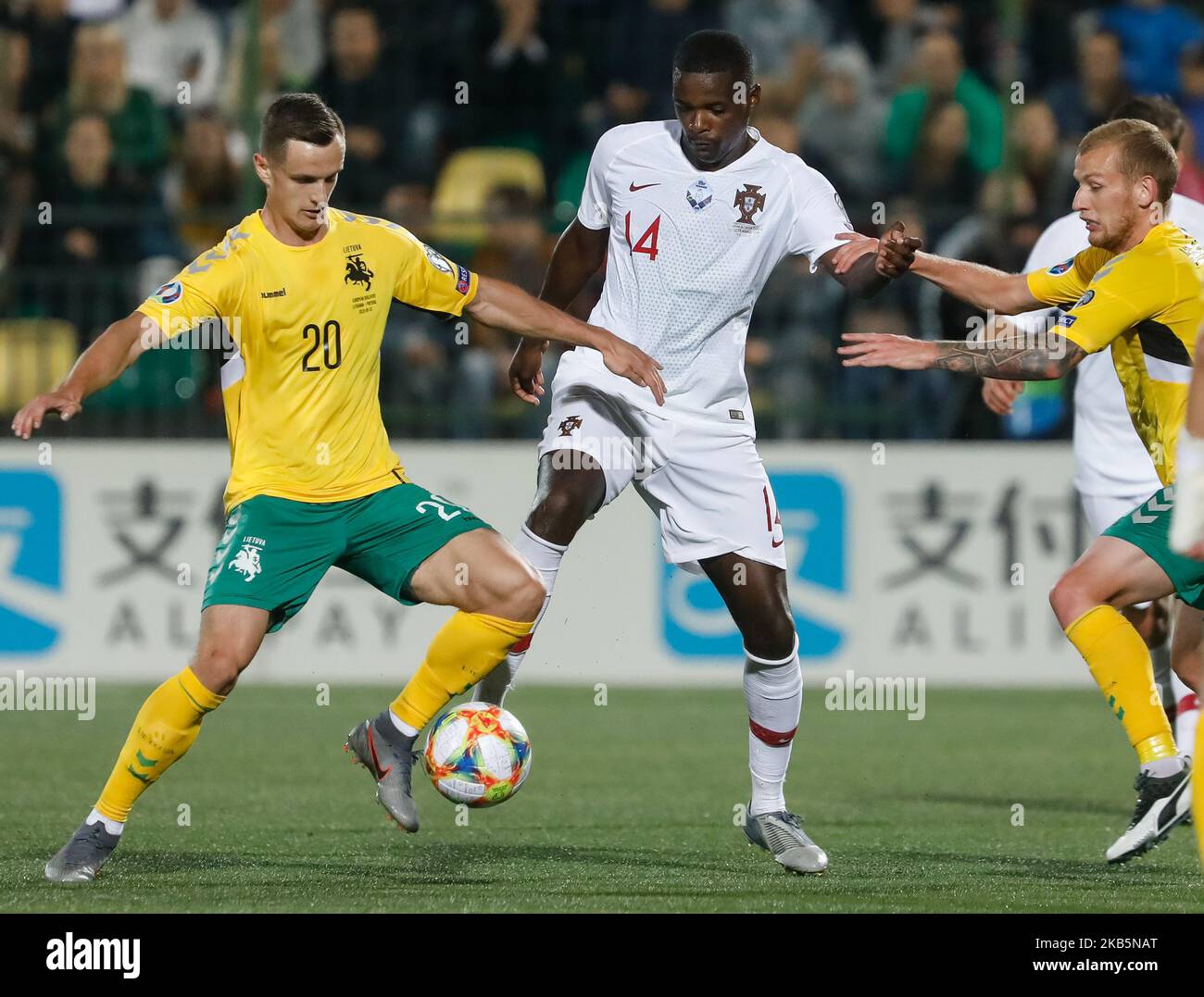 Deimantas Petravicius (L) and Modestas Vorobjovas (R) of Lithuania vie for the ball with William Carvalho of Portugal during the UEFA Euro 2020 qualifying match between Lithuanua and Portugal on September 10, 2019 at LFF Stadium in Vilnius, Lithuania. (Photo by Mike Kireev/NurPhoto) Stock Photo