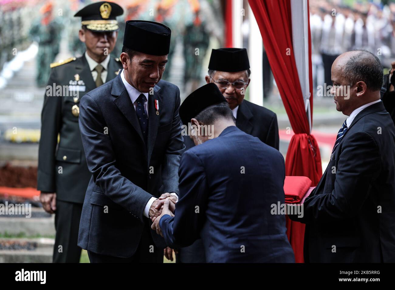 Indonesian President Joko Widodo shakes hand to family former Indonesian President B.J. Habibie