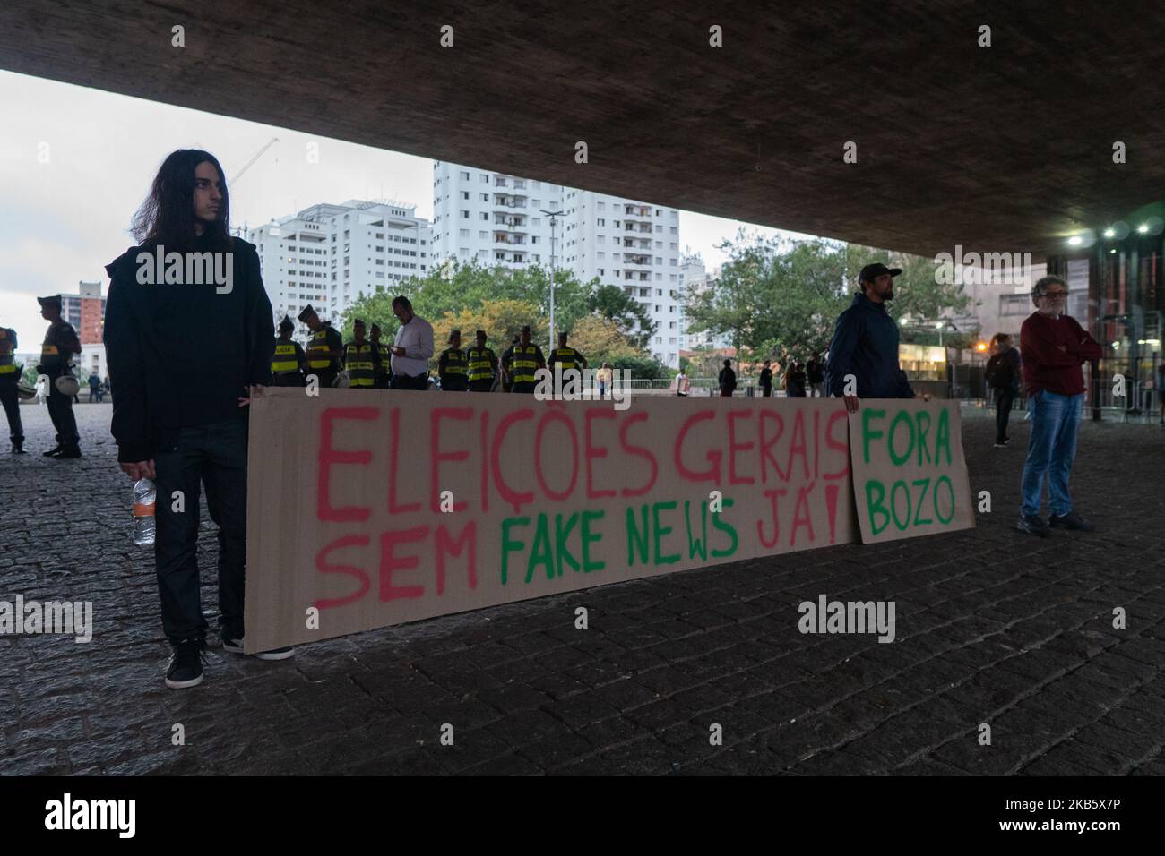 Two demonstrator show a paper, that reads: “general elections without fake news now' and 'out Bozo' (Bozo is a derogatory nickname that refers to a clown and also to the President Jair Bolsonaro) during protest against the President Jair Bolsonaro government at Paulista avenue in São Paulo, Brazil, September 13, 2019. (Footage by Felipe Beltrame/NurPhoto) Stock Photo