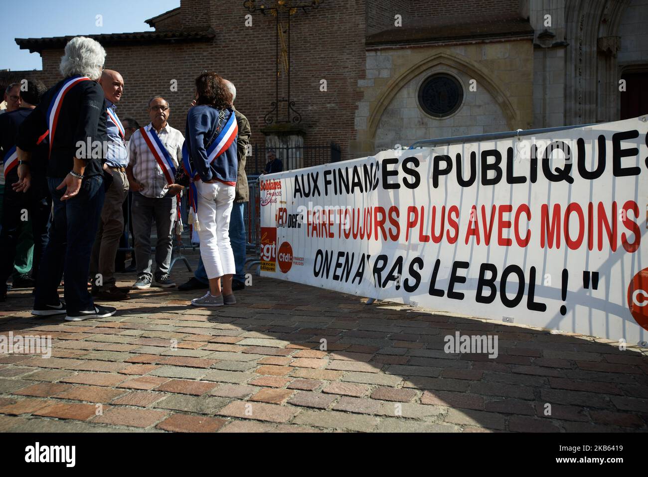 A banner reads 'Public Finance, doing more with less, we're fed up with this'. Civil servants from the DGFIP (General Directorate of Public Finance) and mayors gathered in front of the Prefecture of Haute-Garonne to protest against the Darmanin's plan to close down tax offices across France. Darmaninis the finance minister. In the Haute-Garonne department, 25 tax offices will be closd and in the Lot-et-Garonne department, for example, all tax offices will be closed before 2023. Toulouse. France. September 16th 2019. (Photo by Alain Pitton/NurPhoto) Stock Photo