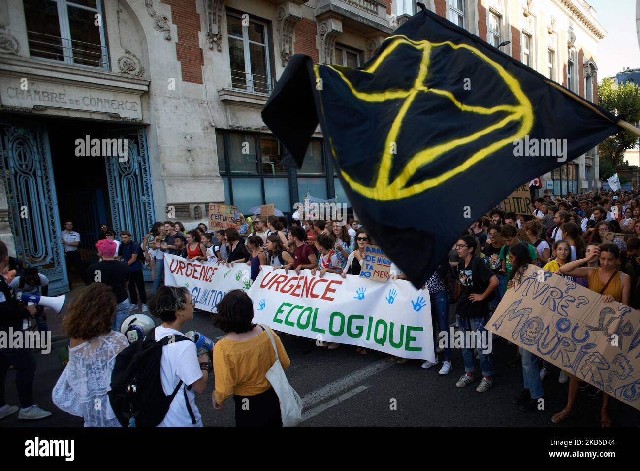 A XR (Extinction Rebellion) flag in front of a banner reading 'Climatic urgency, ecologic urgency'. Following the call of Greta Thunberg for a World School Strike, more than 2500 school students and students took to the streets of Toulouse for the 3rd time to denounce the governments inaction towards the climate crisis. They denounce the lack of action against the environment crisis or the extinction of species. Similar protests took place all over the world. After this protest, they rejoined the March for the Climate.Toulouse. France. September 20th 2019. (Photo by Alain Pitton/NurPhoto) Stock Photo