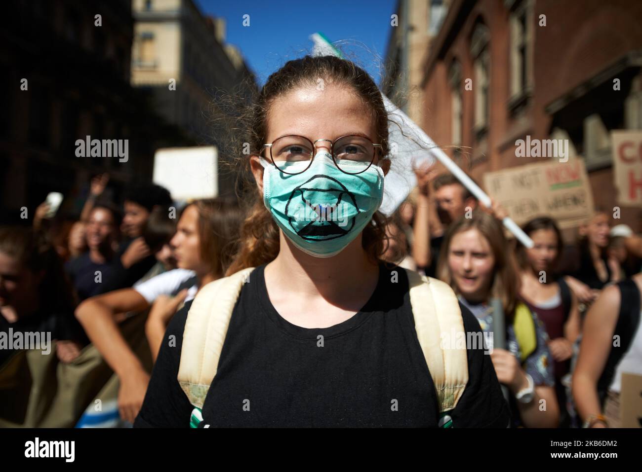 A young woman wears a gas mask with the XR (Extinction Rebellion) symbol: an egg tmier. Following the call of Greta Thunberg for a World School Strike, more than 2500 school students and students took to the streets of Toulouse for the 3rd time to denounce the governments inaction towards the climate crisis. They denounce the lack of action against the environment crisis or the extinction of species. Similar protests took place all over the world. After this protest, they rejoined the March for the Climate.Toulouse. France. September 20th 2019. (Photo by Alain Pitton/NurPhoto) Stock Photo