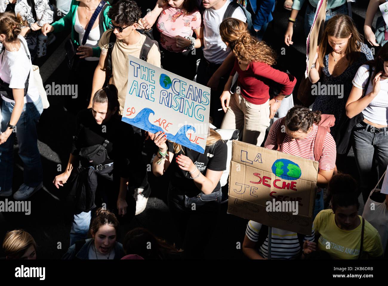 A top view of the procession of young demonstrators holding signs for the climate emergency on which slogans such as "La planète sèche, je sèche les cours" or "The oceans are rising, so we are" can be read this Friday, September 20, 2019 in Paris as part of the global strike day for the climate and the movement initiated by Greta Thunberg "Friday for Future" and organized by the Youth for Climate movement. In Paris, about 9400 young people gathered at Place de la Nation to go to the Bercy garden with numerous signs and slogans reminding the governments of the climate emergency and denouncing t Stock Photo