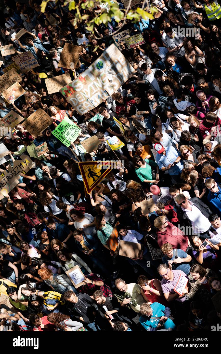 A top view of the procession of young demonstrators holding signs for the climate emergency on which slogans such as 'Si la planète sèche, moi aussi' or 'Stop denying, the earth is dying' can be read, this Friday, September 20, 2019 in Paris as part of the global strike day for the climate and the movement initiated by Greta Thunberg 'Friday for Future' and organized by the Youth for Climate movement. In Paris, about 9400 young people gathered at Place de la Nation to go to the Bercy garden with numerous signs and slogans reminding the governments of the climate emergency and denouncing their  Stock Photo