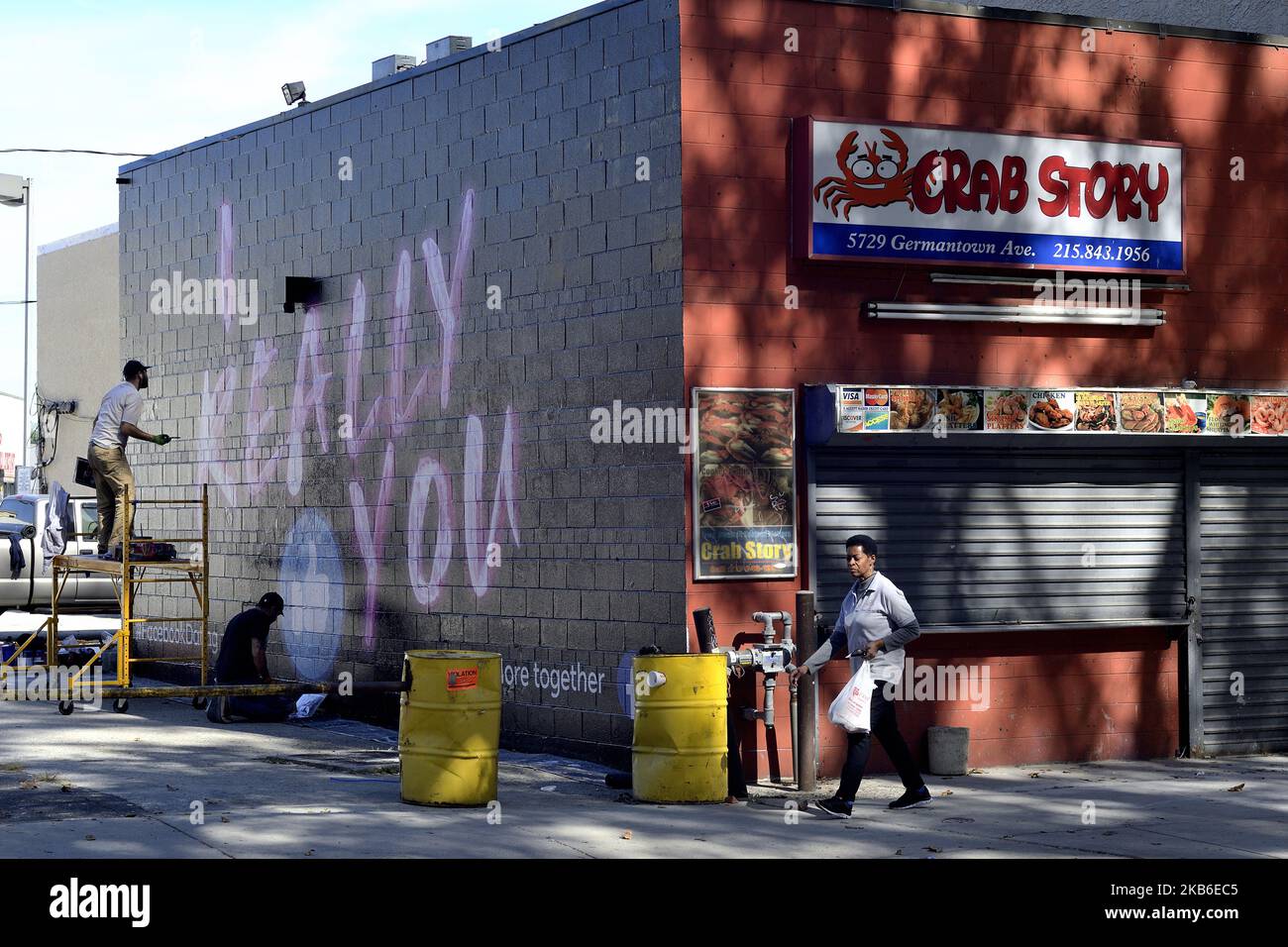 People walk past an advertisement for the Facebook dating service on a sidewall in the Germantown neighborhood of Philadelphia, PA., on September 20, 2019. Guerrilla Advertising style advertisement for the new dating service is found around town. (Photo by Bastiaan Slabbers/NurPhoto) Stock Photo