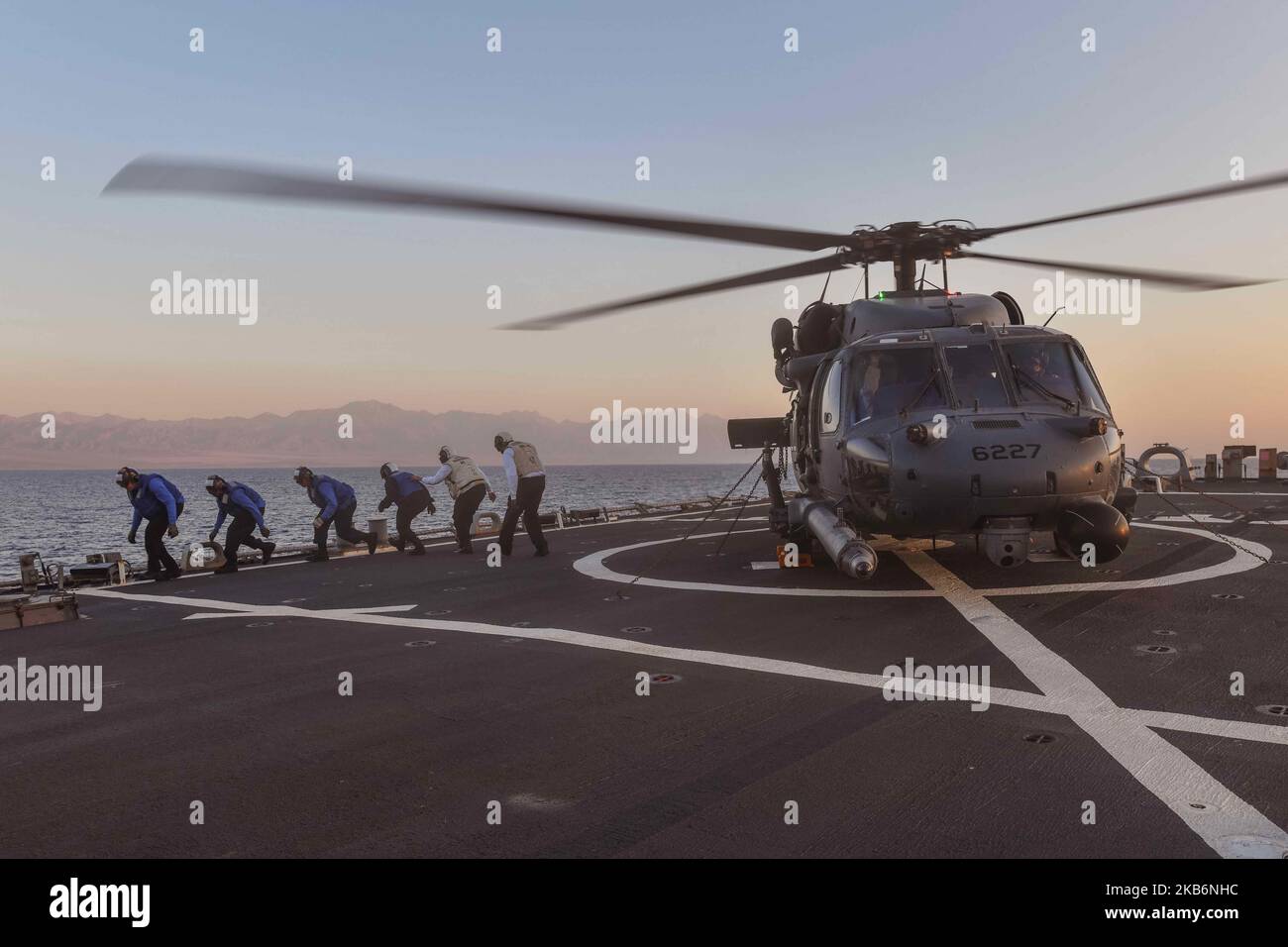 221031-N-RT917-2005 GULF OF AQABA (October 31, 2022) Sailors assigned to the guided-missile destroyer USS The Sullivans (DDG 68) conduct flight operations with a U.S. Air Force HH-60 Pave Hawk helicopter, Oct. 31. The Sullivans is deployed to the U.S. 5th Fleet area of operations to help ensure maritime security and stability in the Middle East region. (U.S. Navy photo by Lt.j.g Kelly Harris) Stock Photo