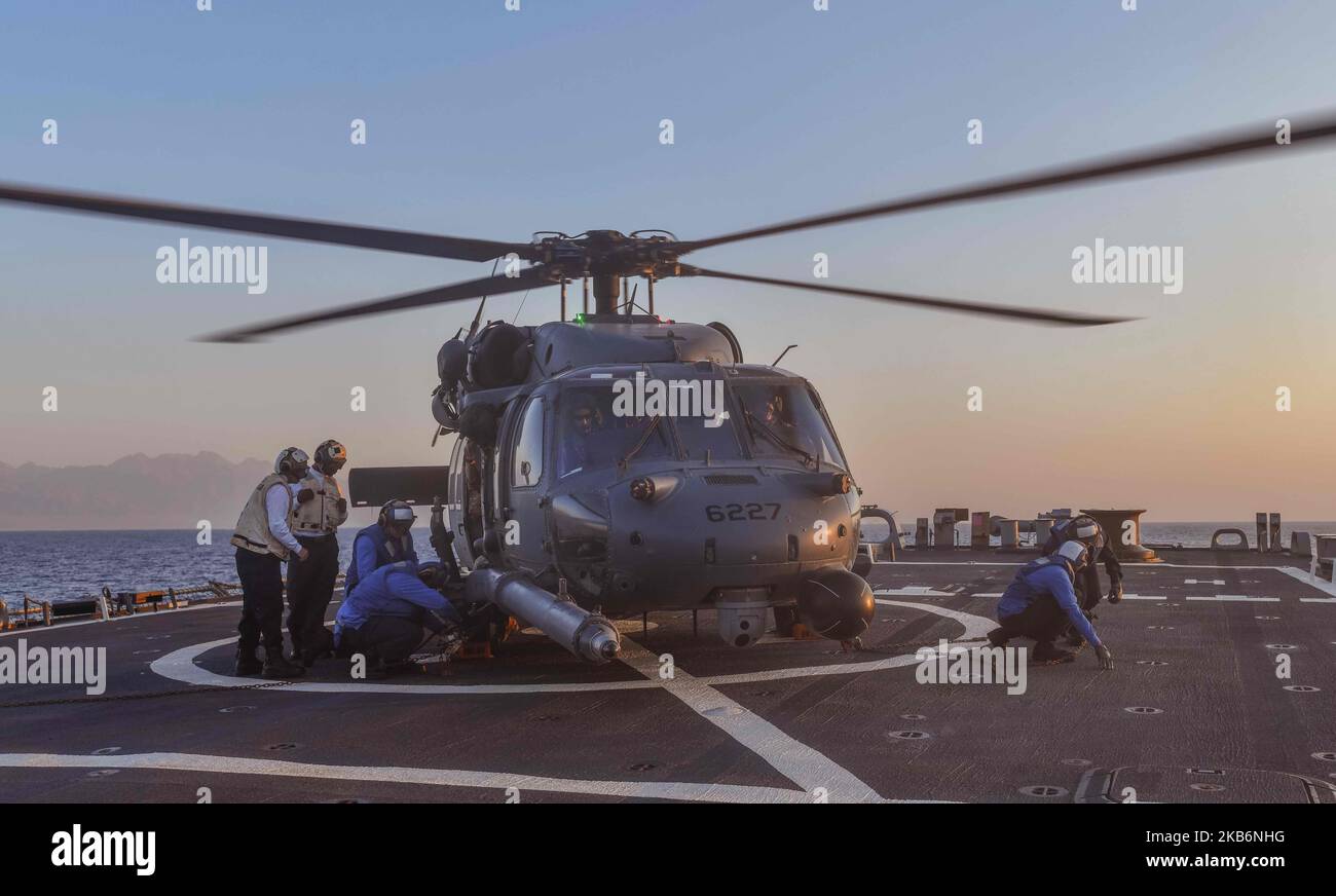 221031-N-RT917-2003 GULF OF AQABA (October 31, 2022) Sailors assigned to the guided-missile destroyer USS The Sullivans (DDG 68) conduct flight operations with a U.S. Air Force HH-60 Pave Hawk helicopter, Oct. 31. The Sullivans is deployed to the U.S. 5th Fleet area of operations to help ensure maritime security and stability in the Middle East region. (U.S. Navy photo by Lt.j.g Kelly Harris) Stock Photo