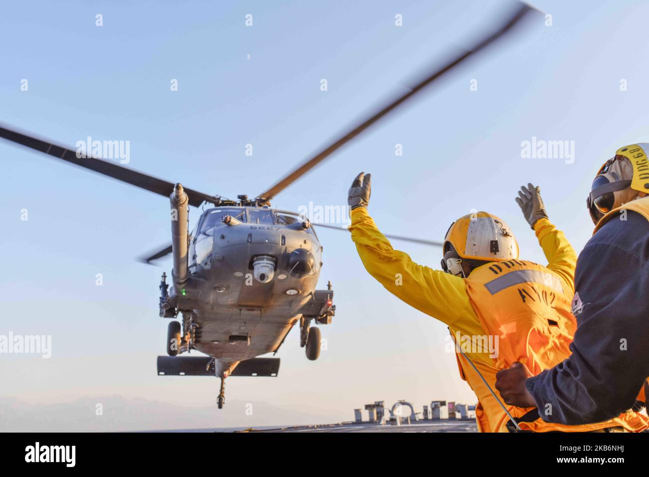 221031-N-RT917-2001 GULF OF AQABA (October 31, 2022) Boatswain’s Mate 2nd Class Brice Smith directs a U.S. Air Force HH-60 Pave Hawk helicopter as it lands on the flight deck of the guided-missile destroyer USS The Sullivans (DDG 68), Oct. 31. The Sullivans is deployed to the U.S. 5th Fleet area of operations to help ensure maritime security and stability in the Middle East region. (U.S. Navy photo by Lt.j.g Kelly Harris) Stock Photo