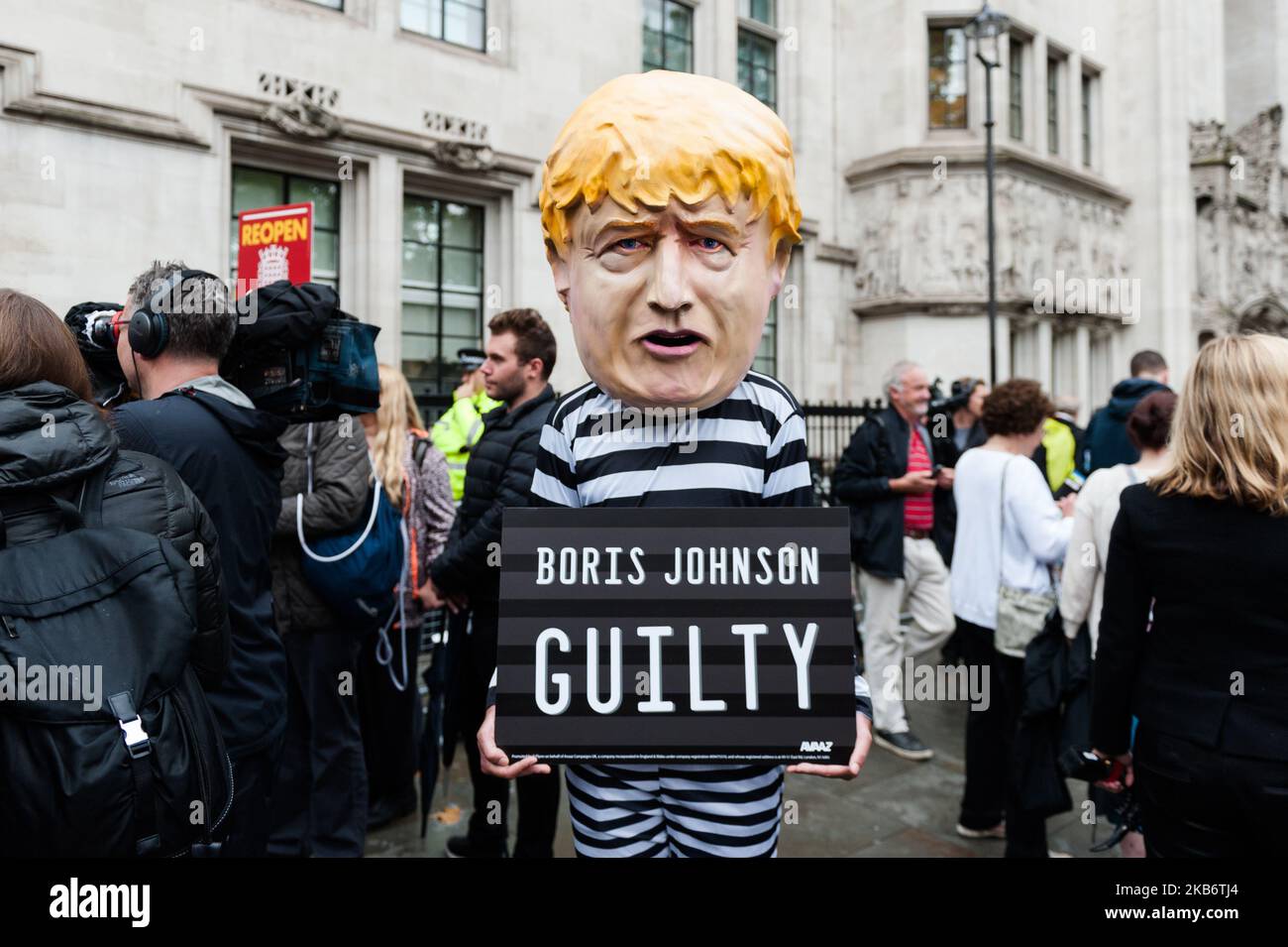 A man dressed as British Prime Minister Boris Johnson in a convict suit holds a sign which reads 'Guilty!' outside the Supreme Court in a stunt organised by Avaaz campaign group on 24 September, 2019 in London, England. Judges of the Supreme Court gave a verdict that Prime Minister Boris Johnson acted unlawfully in advising the Queen to prorogue parliament for five weeks. (Photo by WIktor Szymanowicz/NurPhoto) Stock Photo