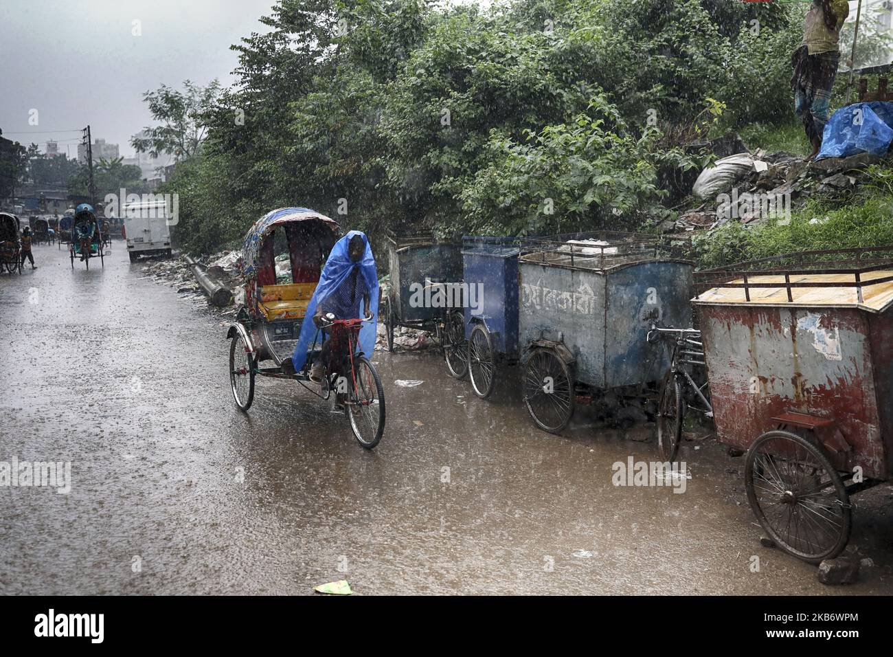 Rickshaws try driving with passengers through the heavy rainfalls in Dhaka Bangladesh on September 25, 2019. (Photo by Kazi Salahuddin Razu/NurPhoto) Stock Photo