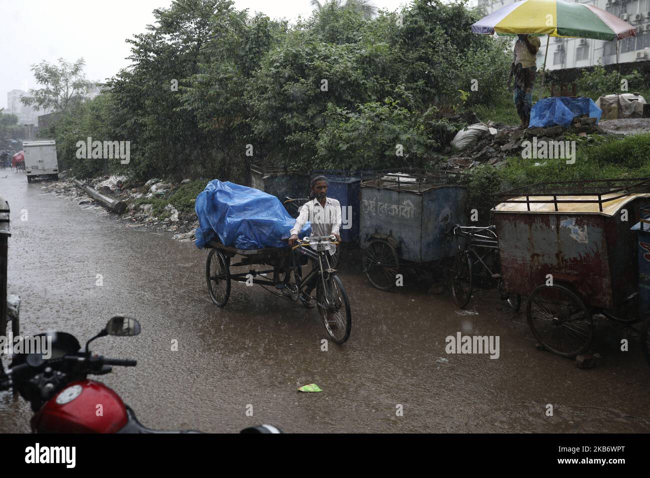 Rickshaws try driving with passengers through the heavy rainfalls in Dhaka Bangladesh on September 25, 2019. (Photo by Kazi Salahuddin Razu/NurPhoto) Stock Photo