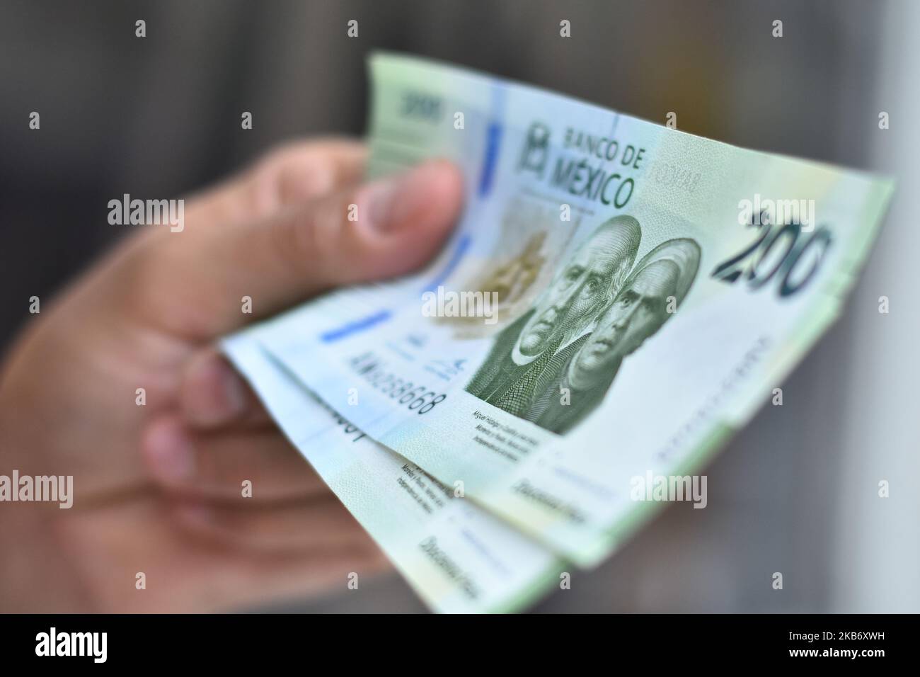 A girl holds the new model of 200 Mexican peso bill that are already in