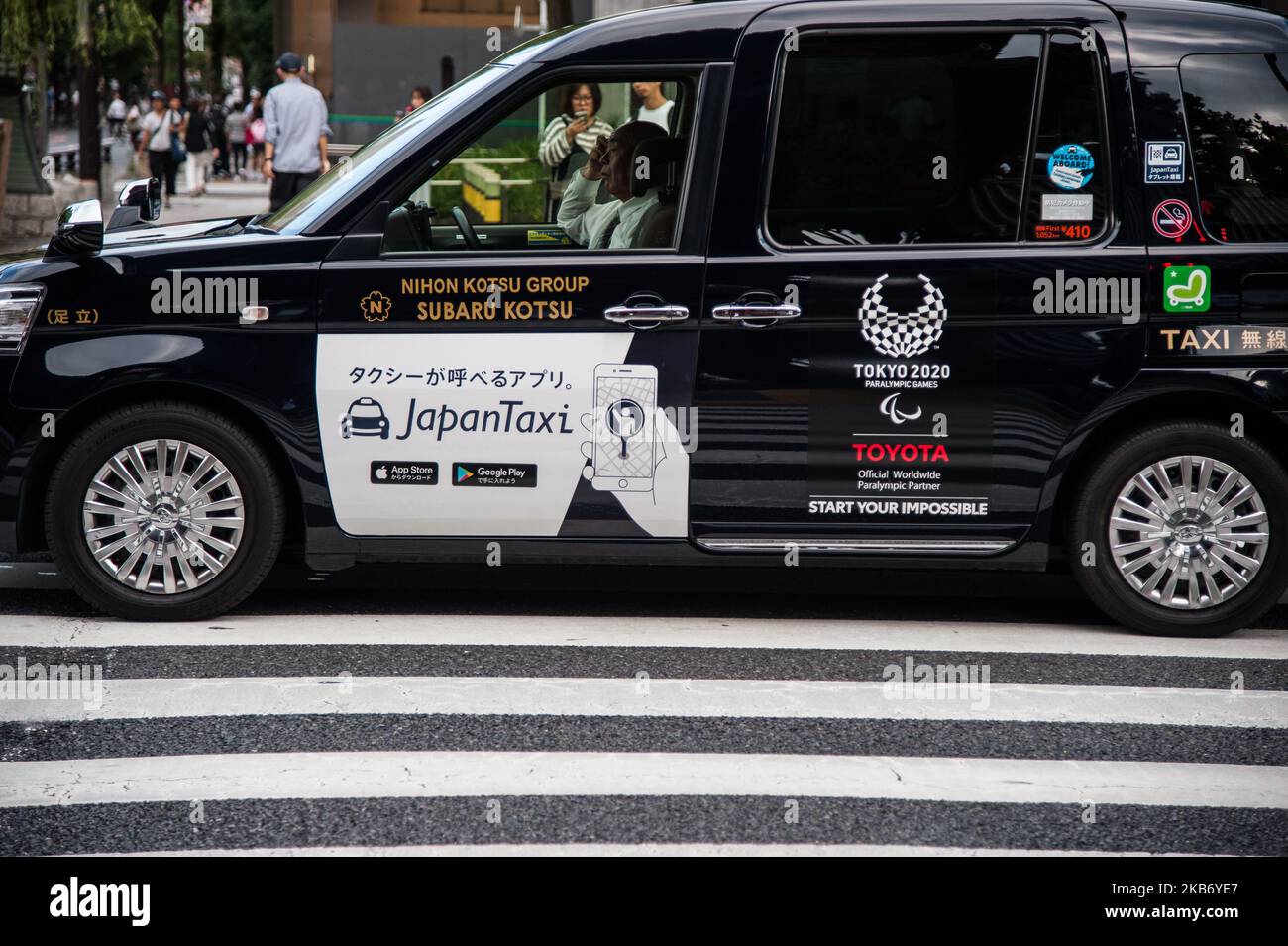 Taxi With Signs Of Tokyo Olympic Games 2020 In The City Center Of Tokyo taxi-with-signs-of-tokyo-olympic-games-2020-in-the-city-center-of-tokyo