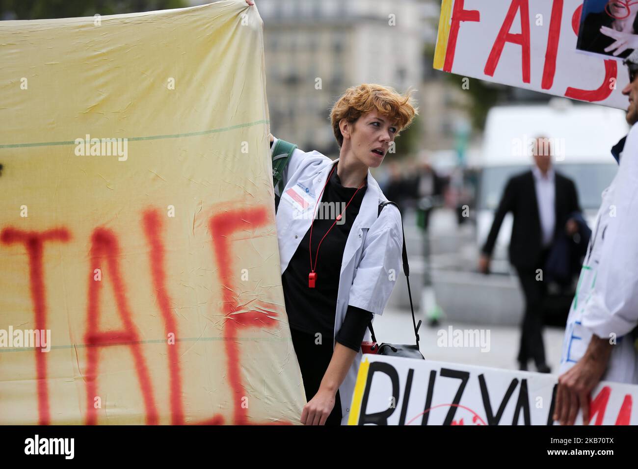 Doctors, nurses and cargivers gather in Paris in front the Hotel de Ville, outside the headquarter of Assistance publique and Hôpitaux de Paris or AP-HP, public hospital system of Paris, to improve the working conditions in the French emergencies services, on September 26, 2019. Emergency hospital staff in France are continuing to strike, with almost half of services affected five months in to the movement. (Photo by Michel Stoupak/NurPhoto) Stock Photo
