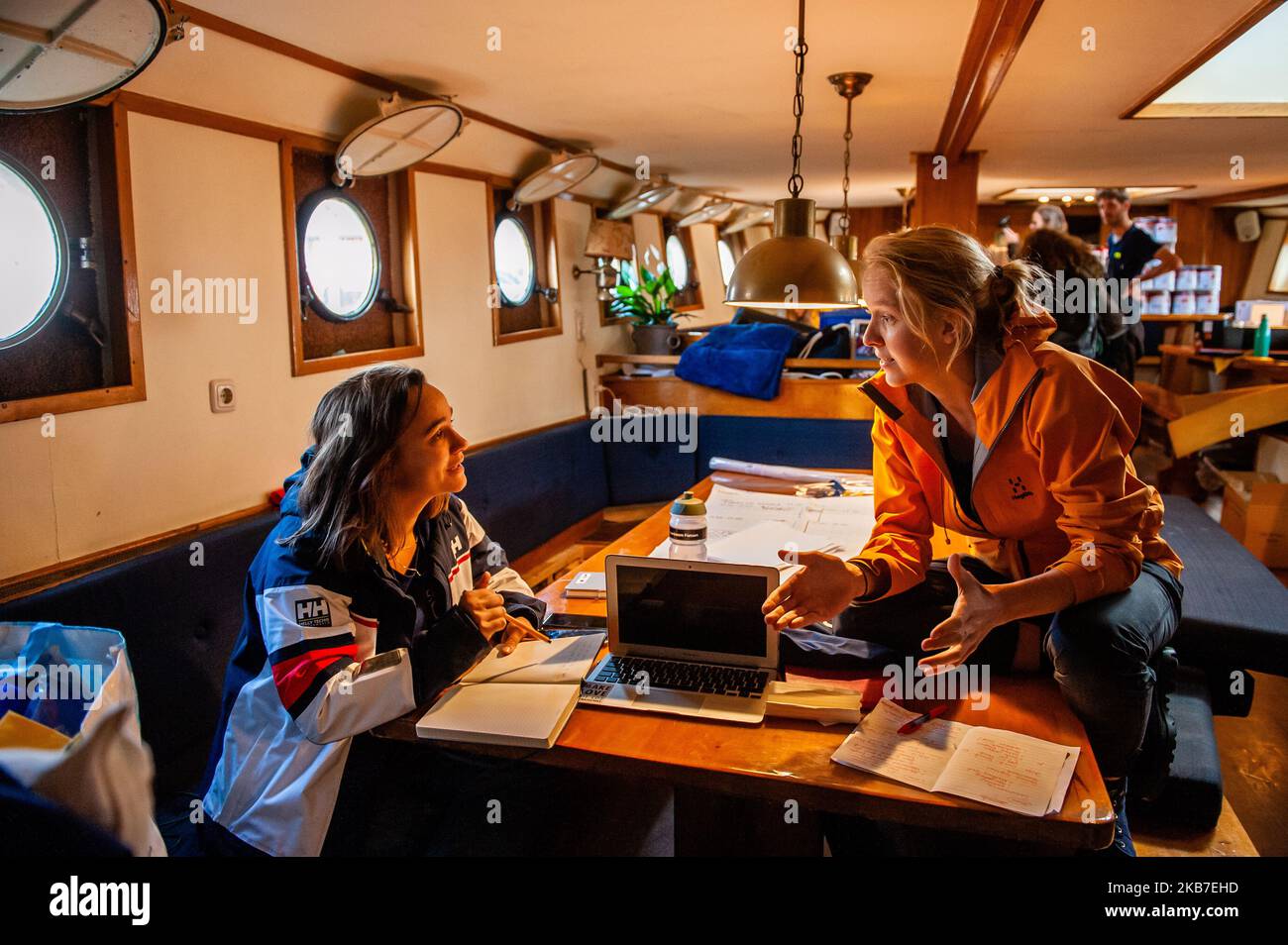 Two climate activist are seen talking about the route aboard of the boat from where they are going to be sailing to COP25 in Chile. Amsterdam, October 2nd, 2019. (Photo by Romy Arroyo Fernandez/NurPhoto) Stock Photo