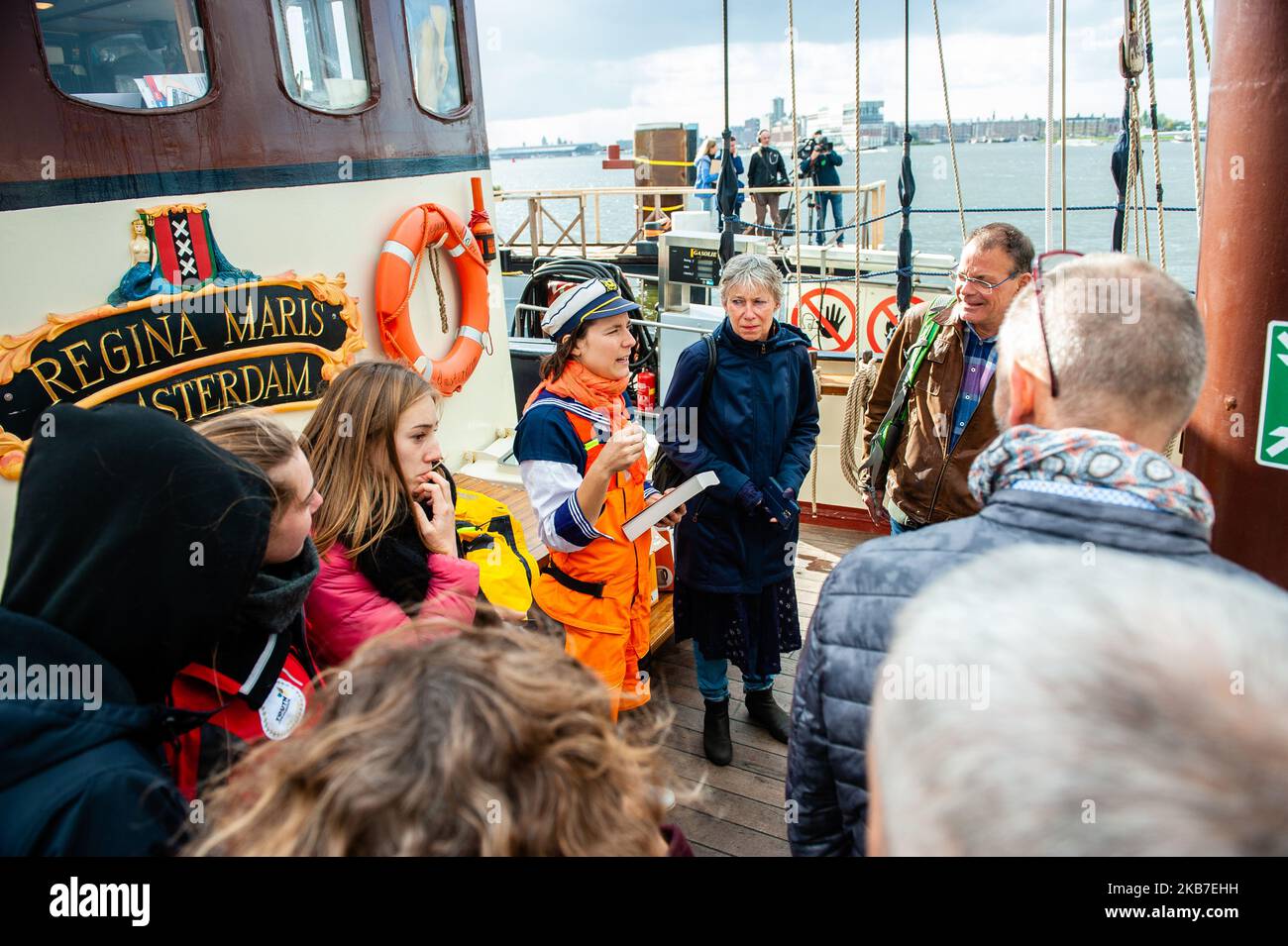 One of the activists is seen giving a tour to the relatives before the boat from where the climate activists are going to be sailing to COP25 in Chile, depart. Amsterdam, October 2nd, 2019. (Photo by Romy Arroyo Fernandez/NurPhoto) Stock Photo