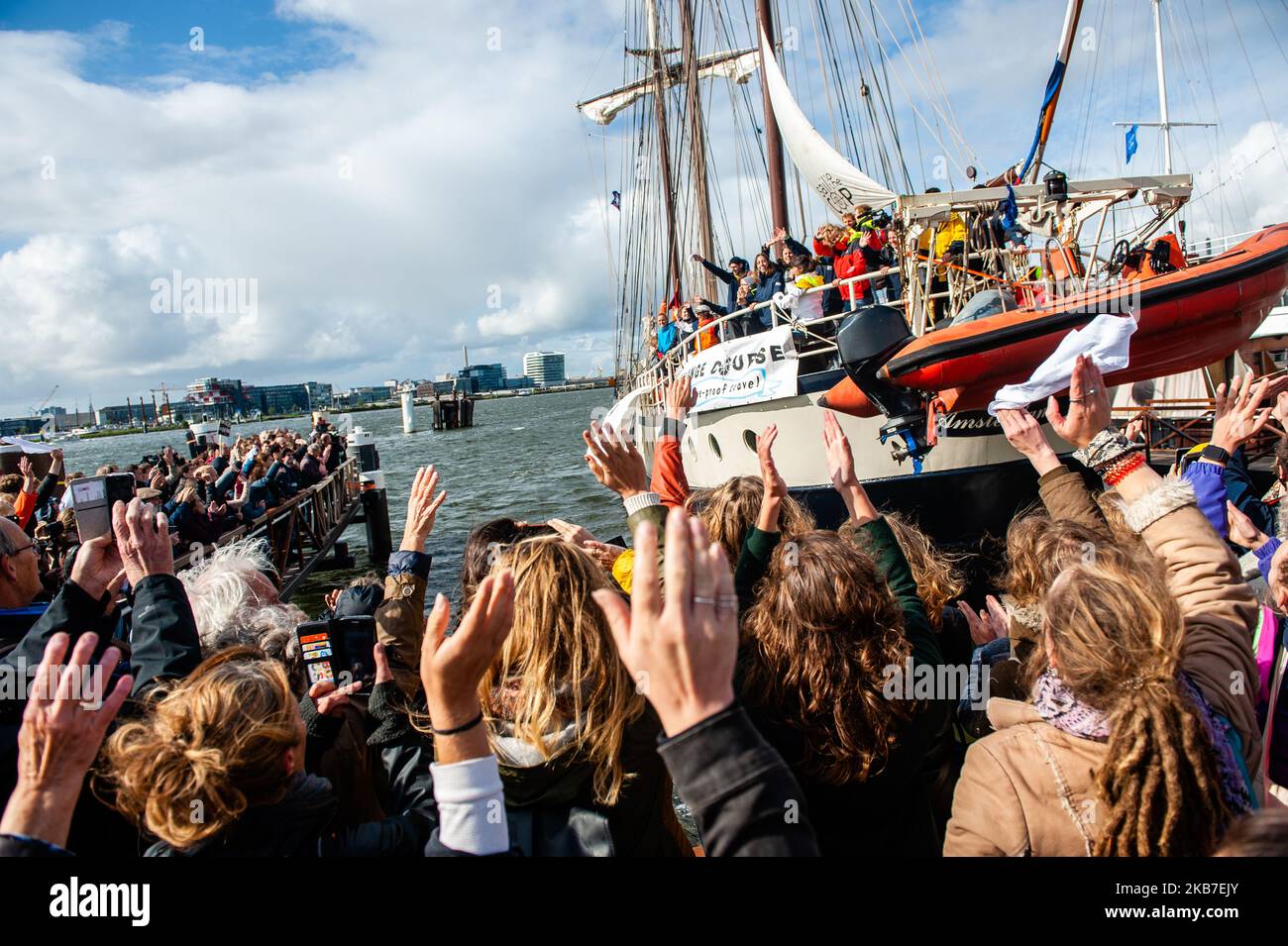 The group of climate activists are seen saying goodbye from the boat just departing where they are going to be sailing to COP25 in Chile. Amsterdam, October 2nd, 2019. (Photo by Romy Arroyo Fernandez/NurPhoto) Stock Photo